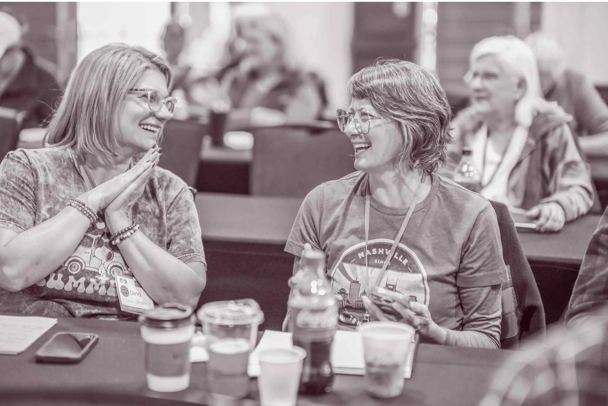  Conference attendees smiling and connecting during a Connect to Empower community gathering 