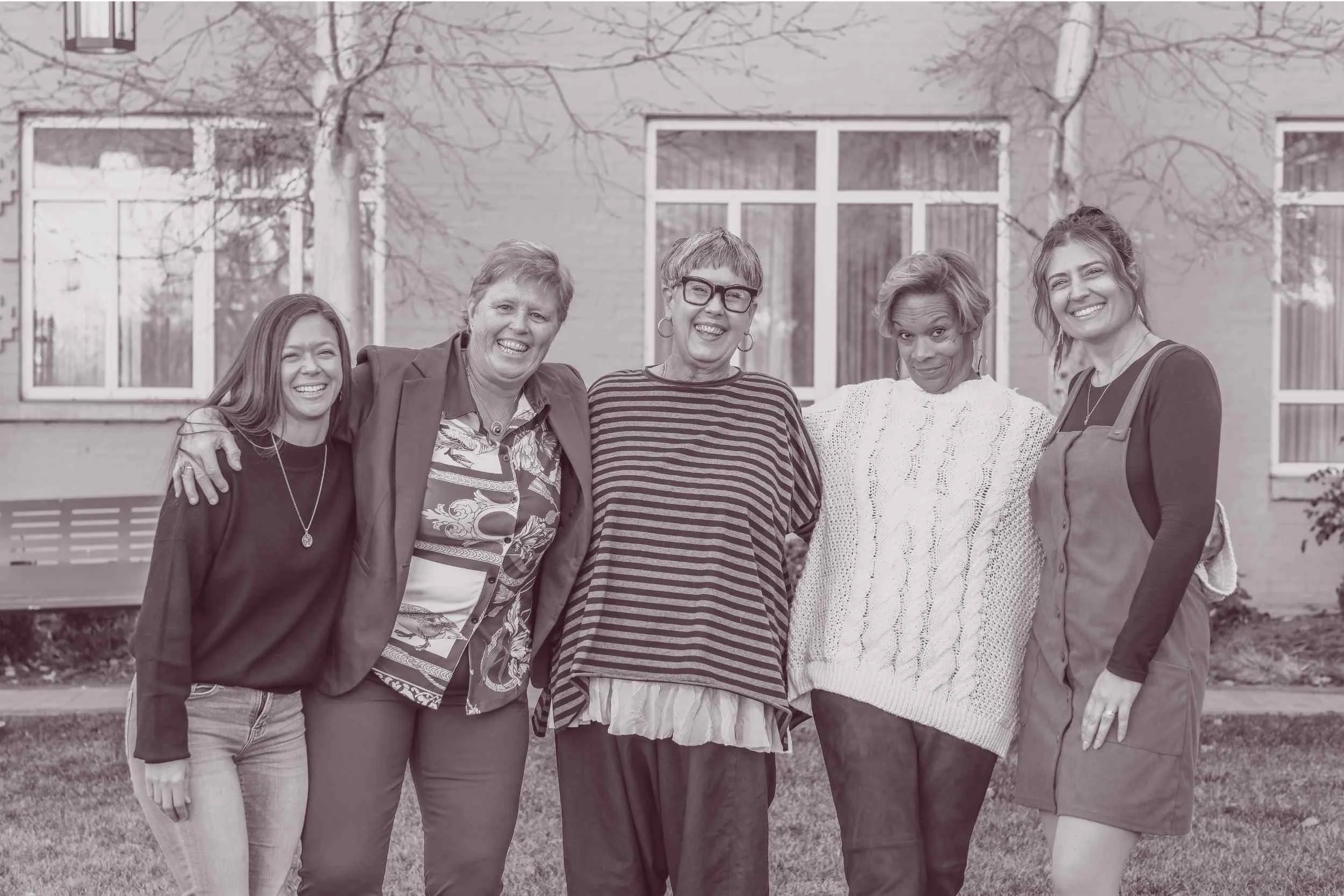  Susan Lynn posing with event attendees during a spiritual community conference experience 
