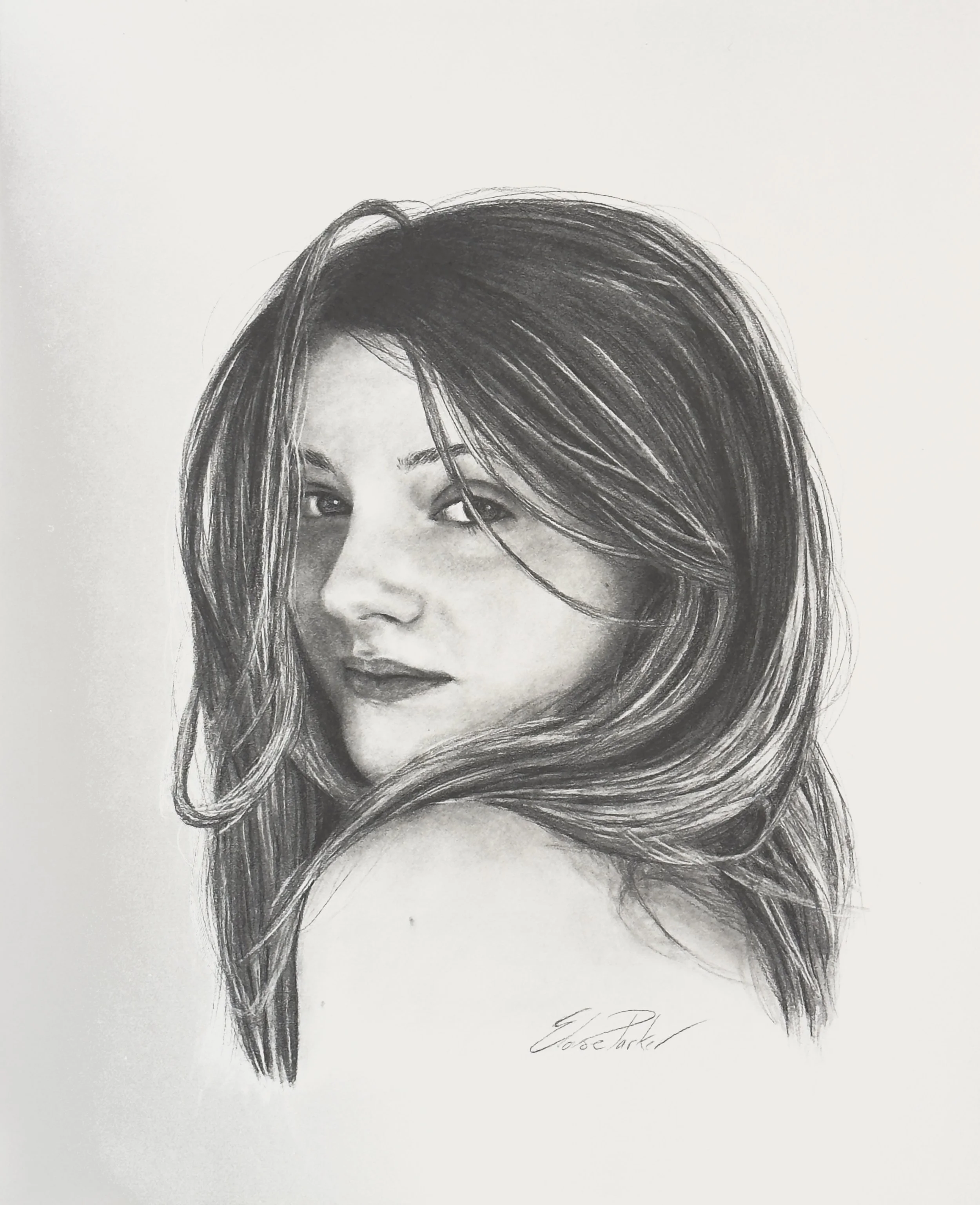 A detailed black-and-white pencil portrait of a woman with long, wavy hair looking over her shoulder. Copyright Eloise Parker.