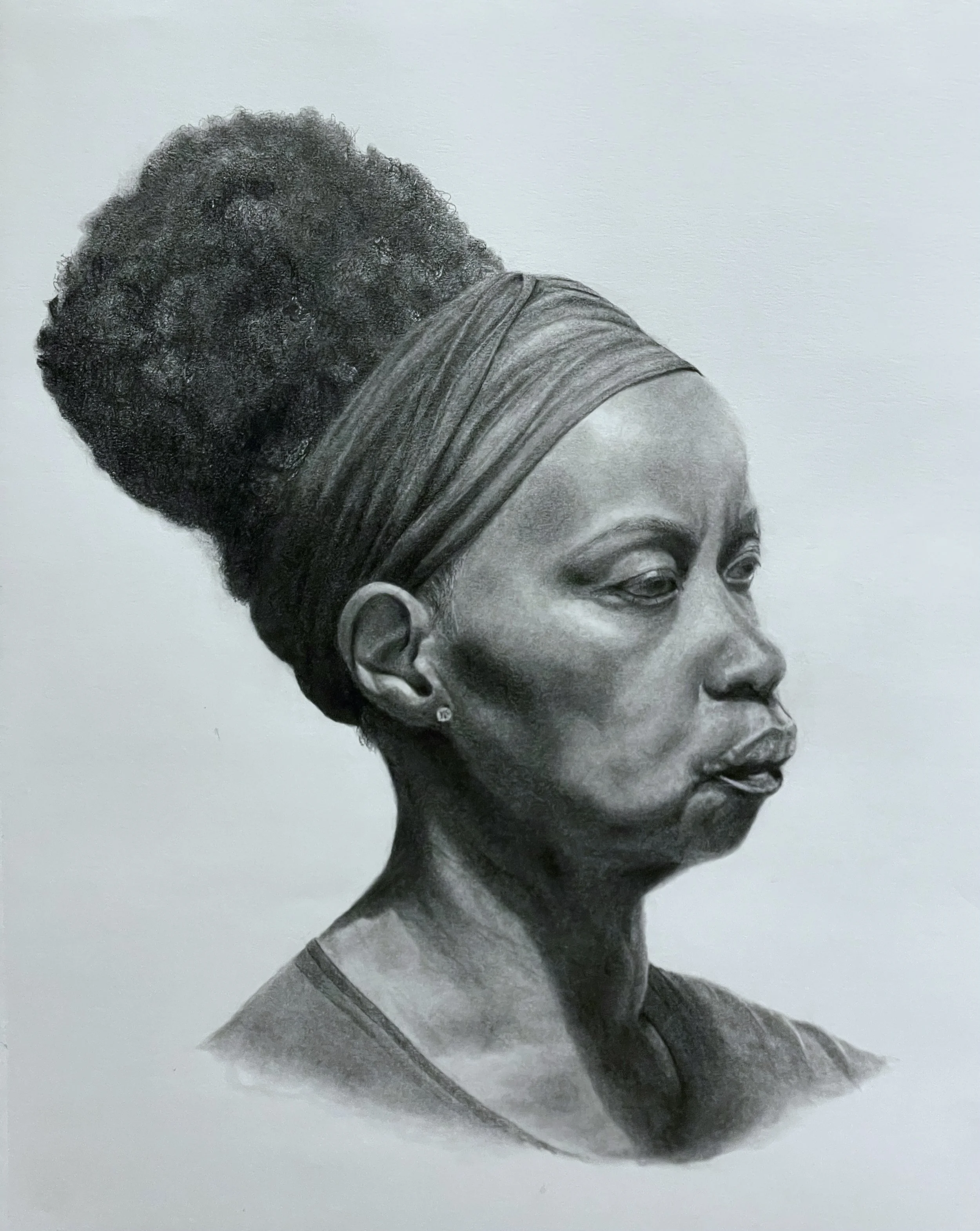 Black and white portrait drawing of an African-American woman with a high, textured bun and a headwrap. Copyright Eloise Parker.