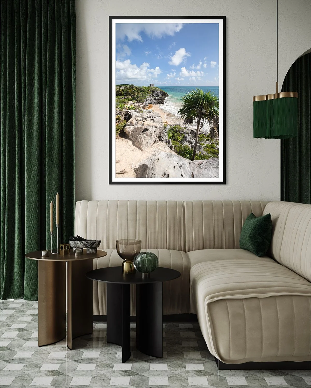 Interior of a room with green curtains, a framed photo of a beach landscape on the wall, a beige sectional sofa with a green pillow, and three small round tables decorated with vases and candles.