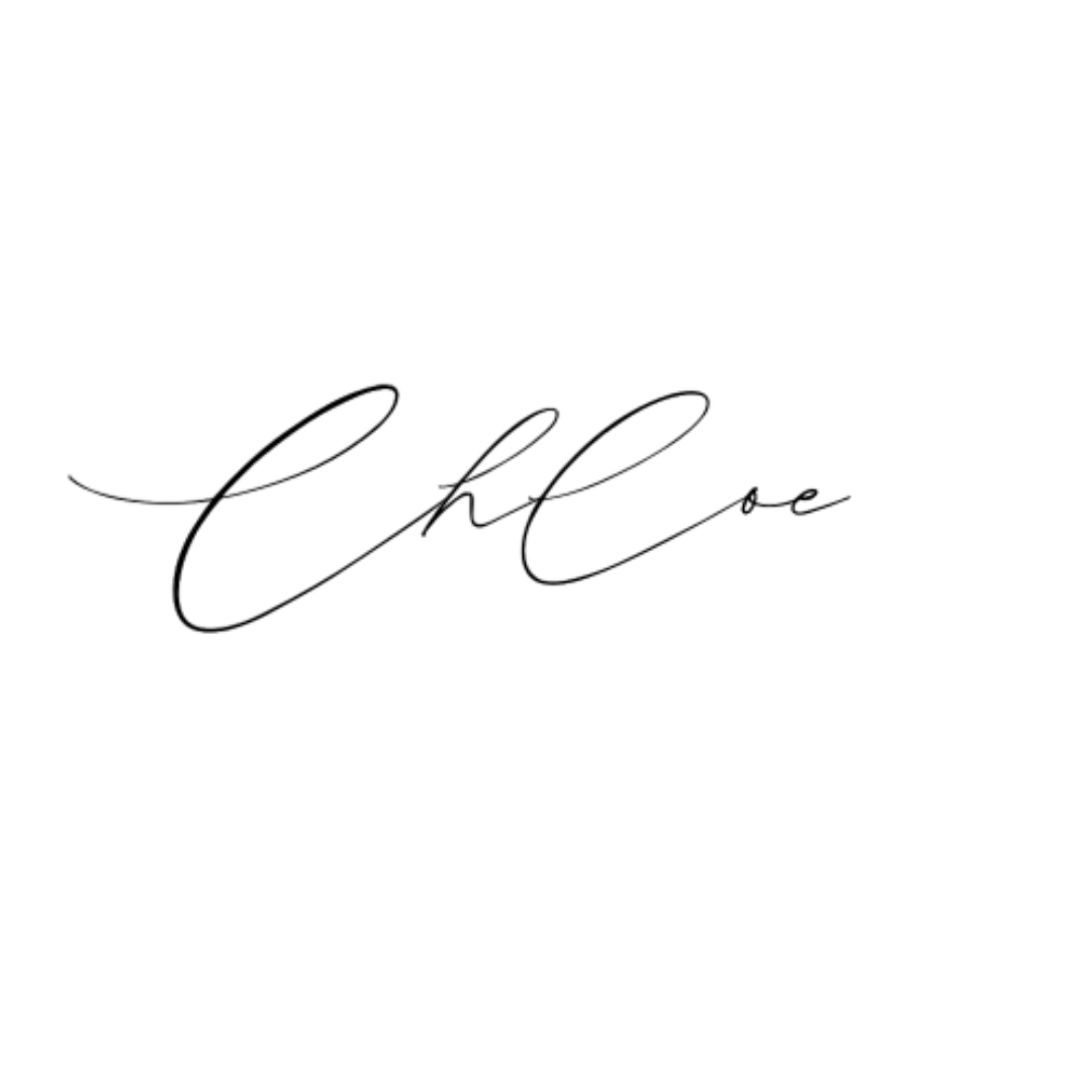 Close-up of a silver, cursive metal plaque spelling "Hello" on a black background.