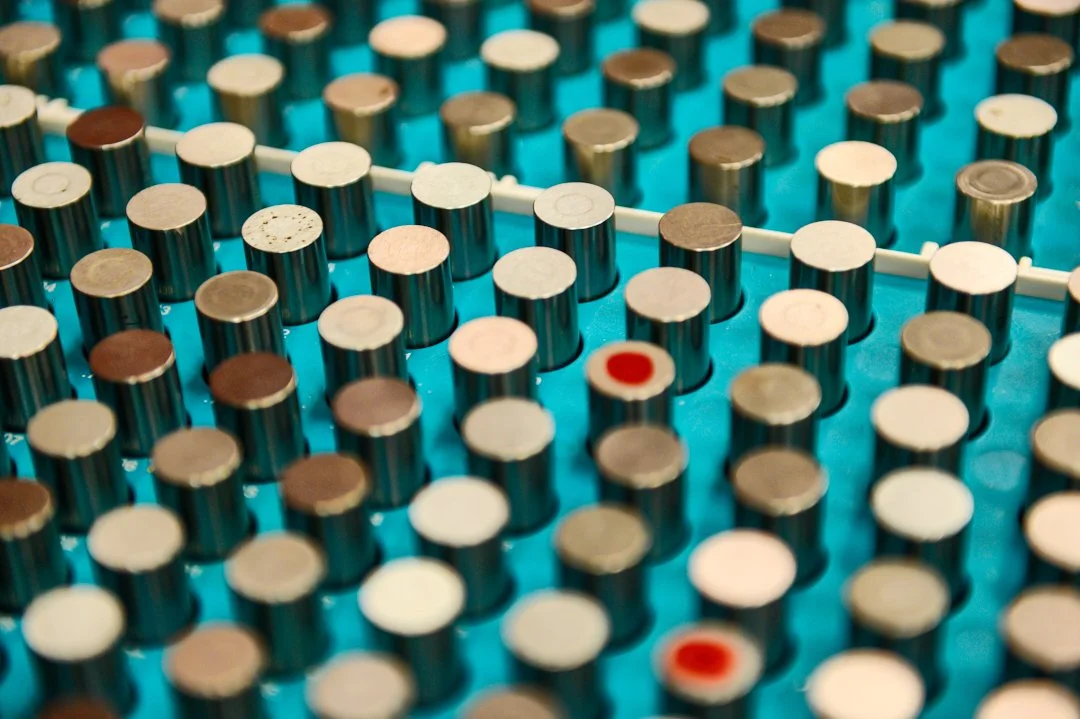 Close-up of a vintage typewriter keyboard showing round keys with various colors and prints.