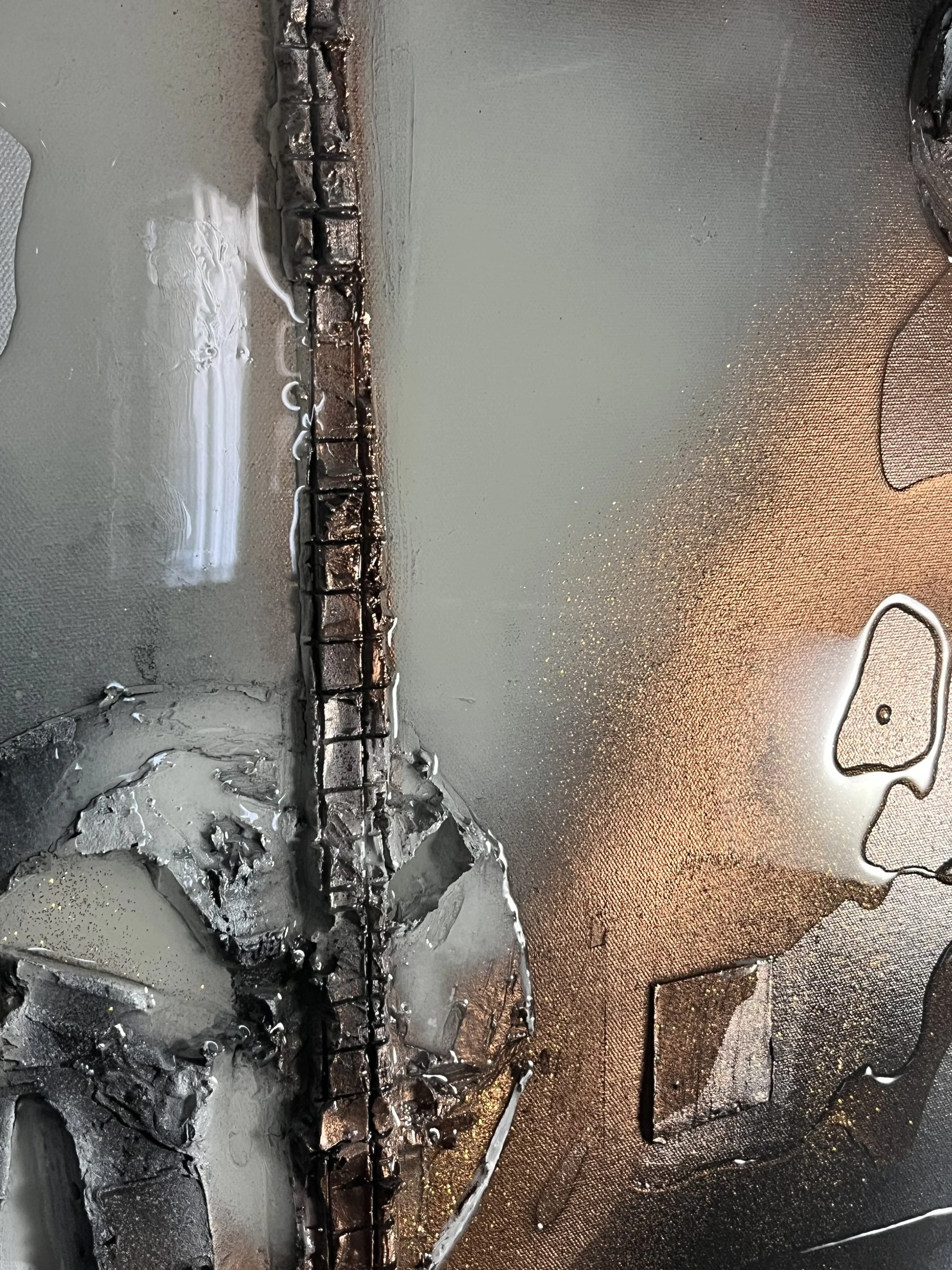 Close-up of a damaged metallic surface with a long crack, burned or melted areas, and some liquid residue.