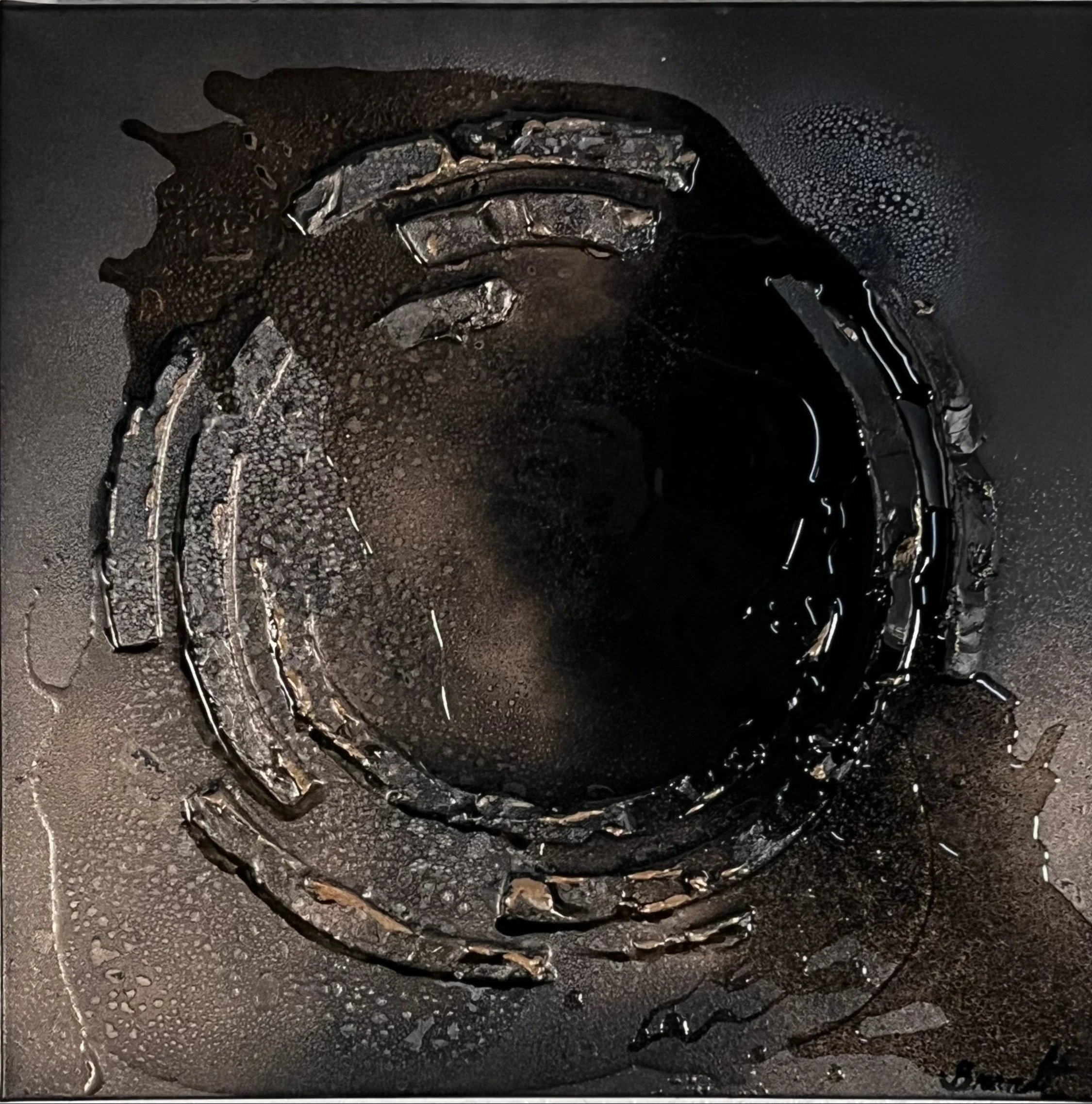 Close-up of a car tire with melted and deformed rubber, possibly after a fire or extreme heat.