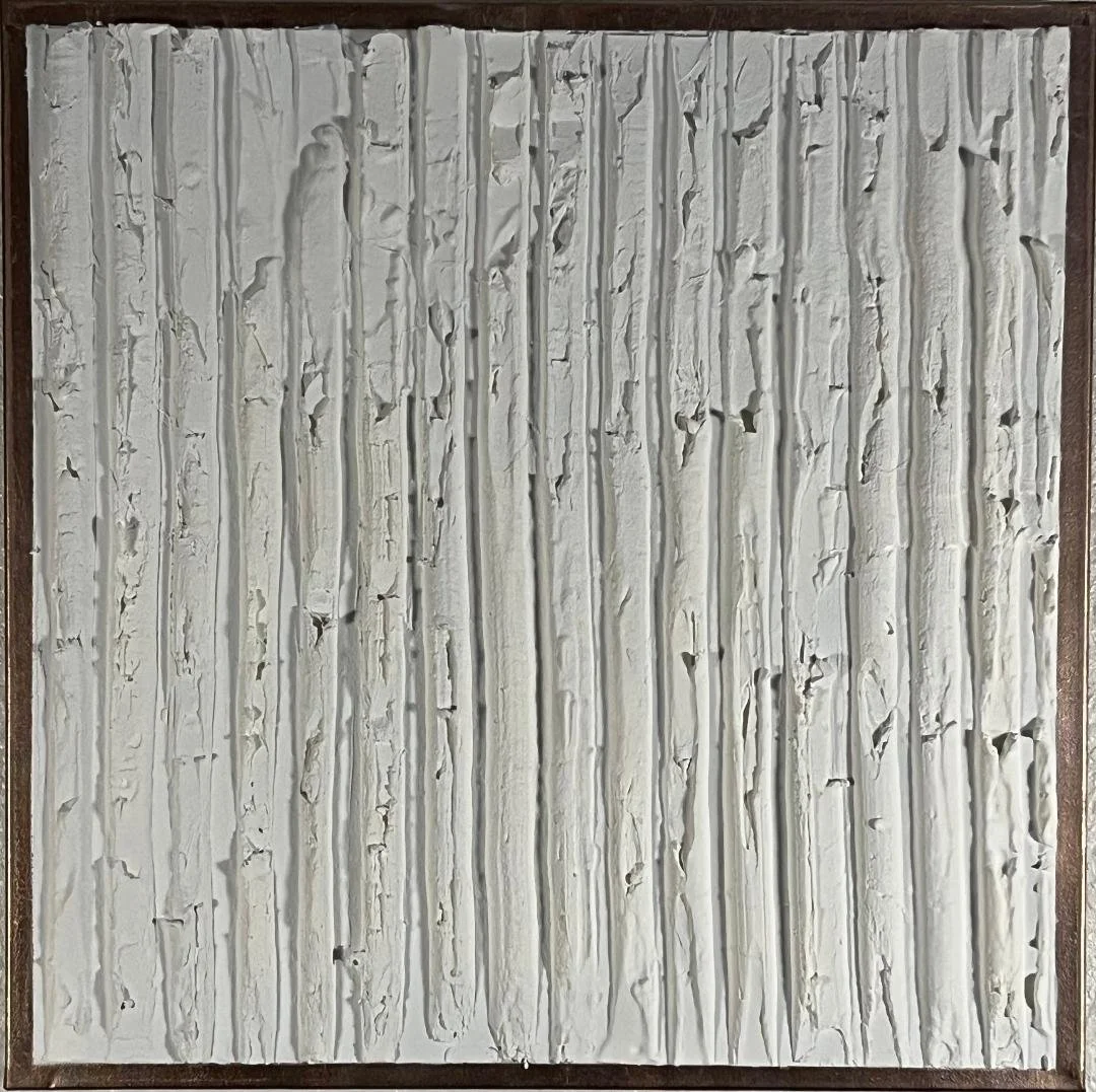 A textured abstract painting with vertical white and gray streaks and cracks, framed in a dark wood frame.
