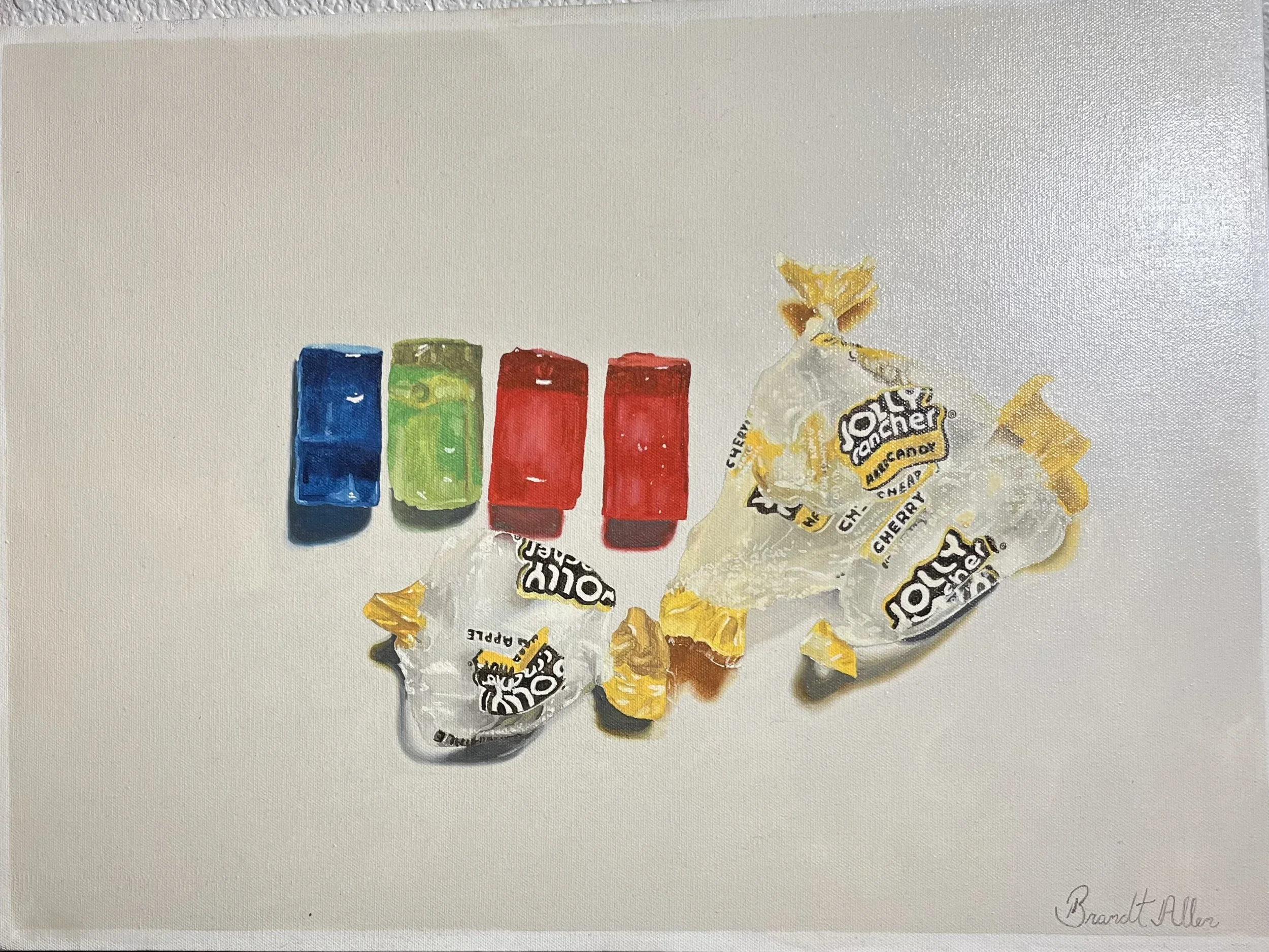 A still life painting of a crumpled candy wrapper and three colorful lipstick tubes in blue, green, and red, arranged in a row on a white background, created with oil paint. The artist's signature 'Brandi Allen' is visible in the lower right corner.