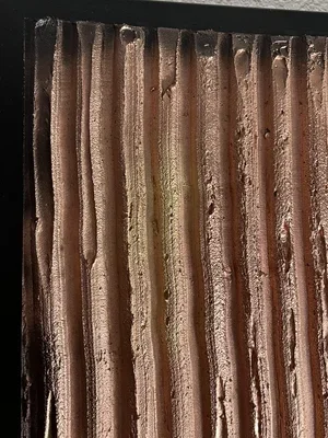 Close-up of a rusty corrugated metal surface.
