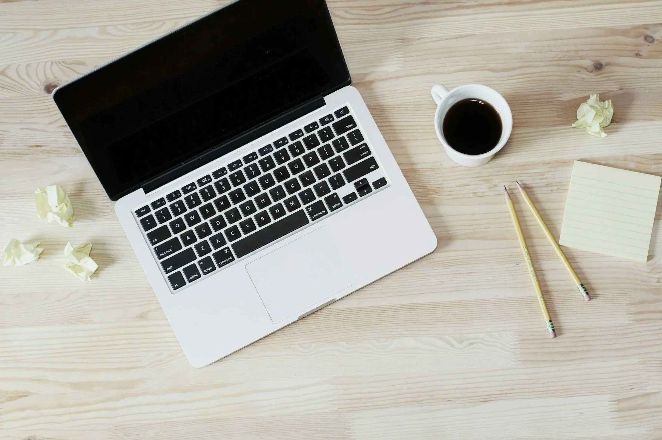 Bookkeeping workspace for CPA with laptop, notebook, and coffee