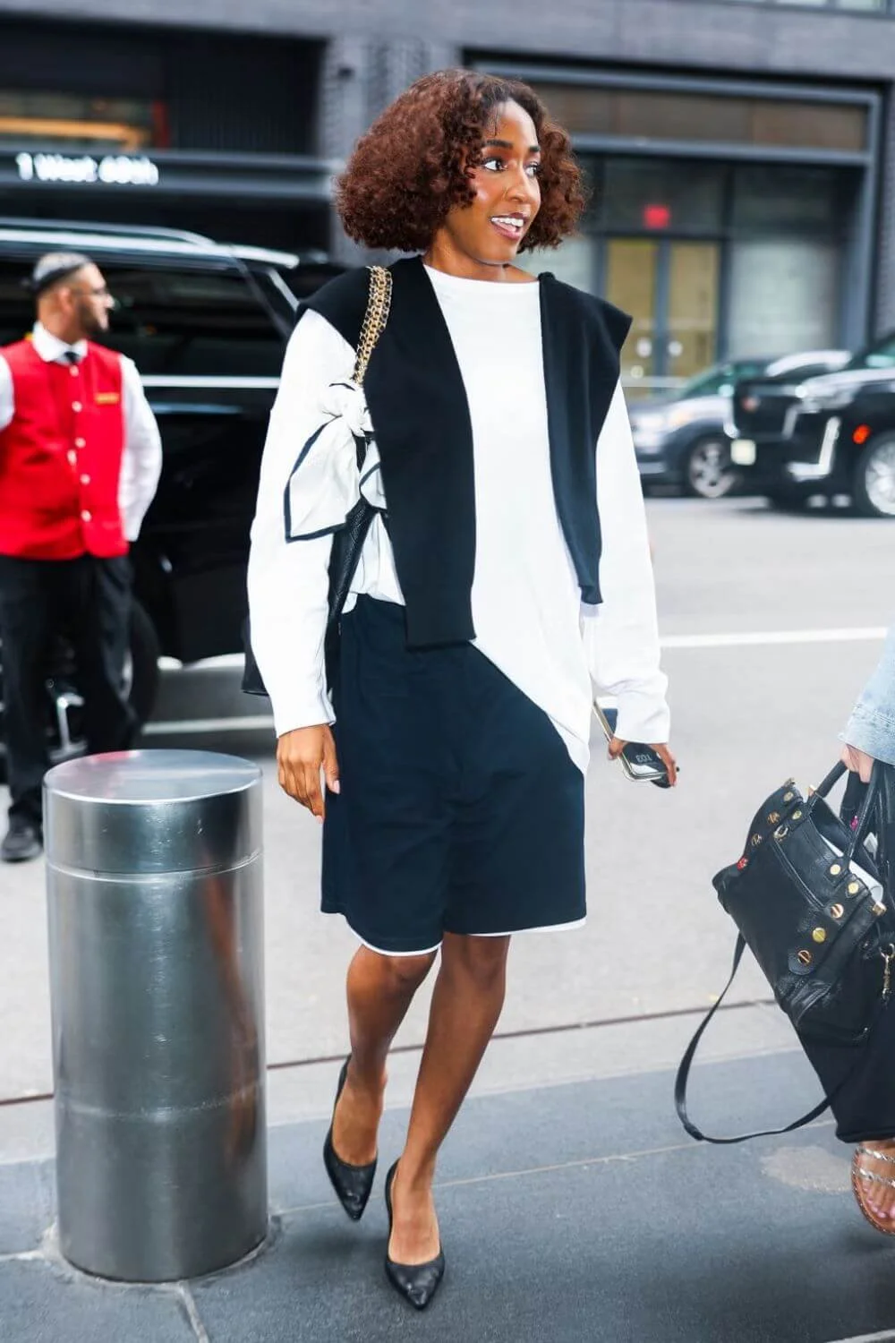 ayo-edebiri-off-duty-style-white-top-navy-shorts-black-flats.jpg