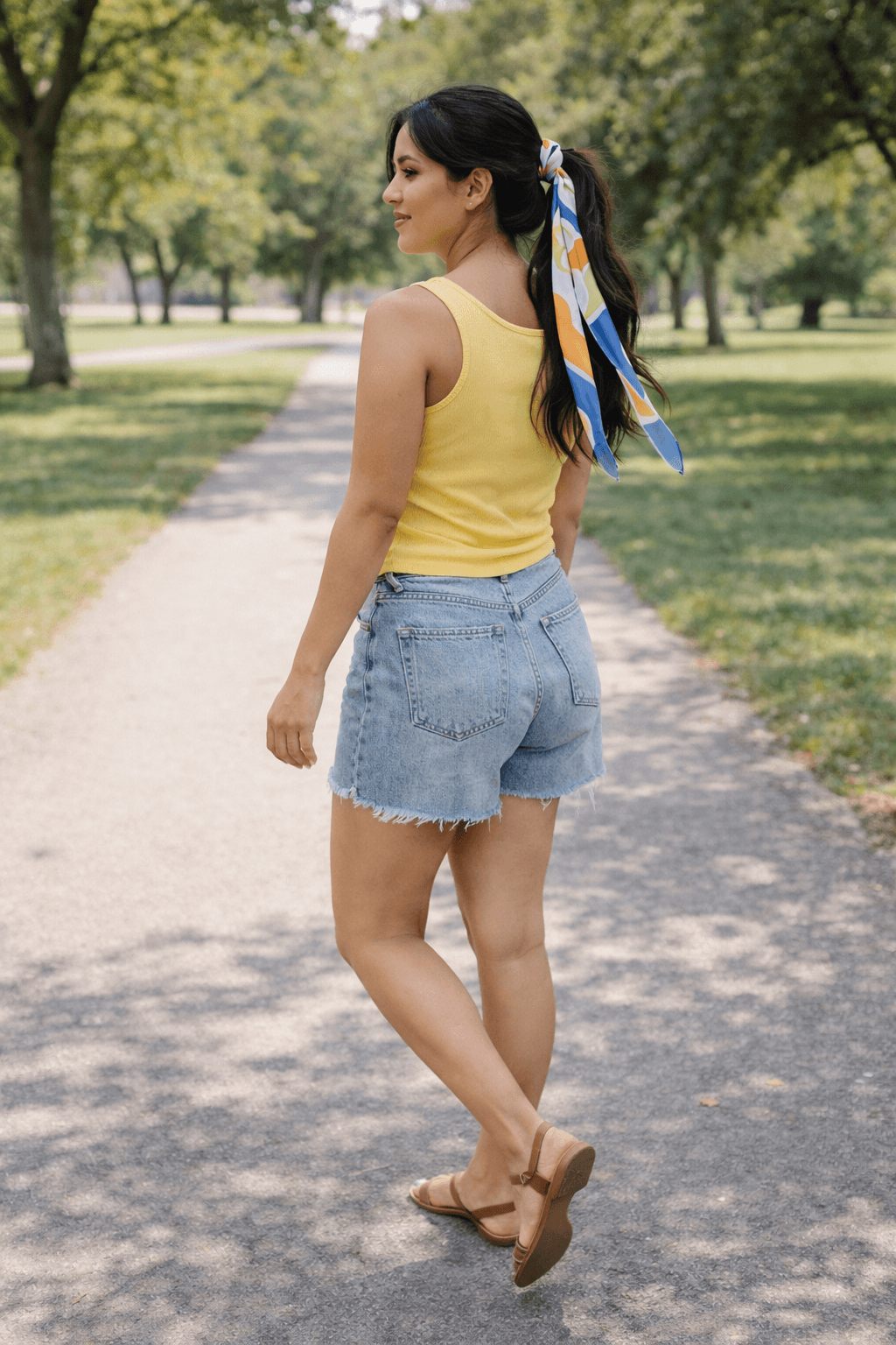 scarf wrapped ponytail with tank top and denim shorts casual summer outfit