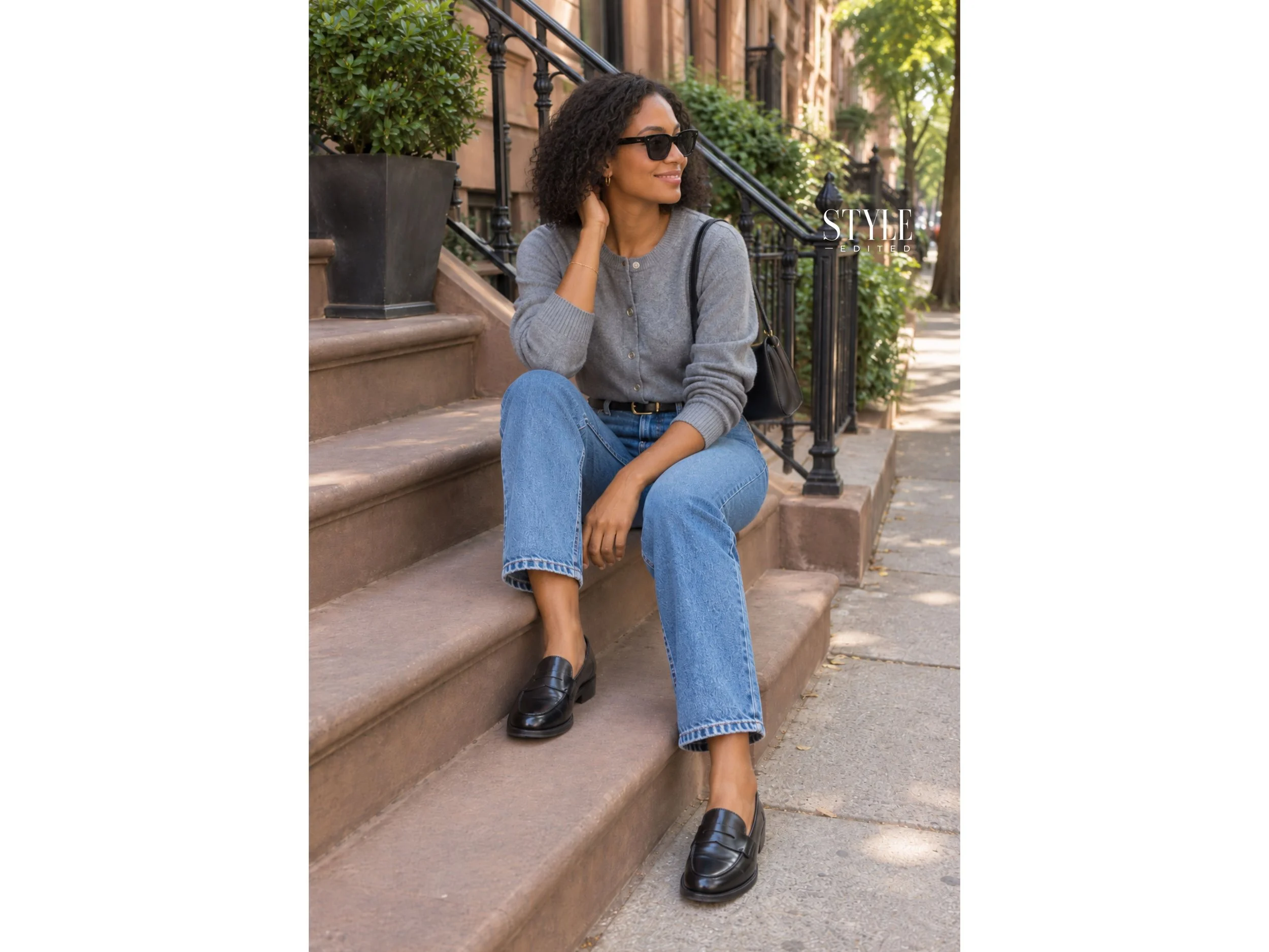 Woman in straight jeans, a gray cardigan, and loafers styled in a relaxed everyday city look.