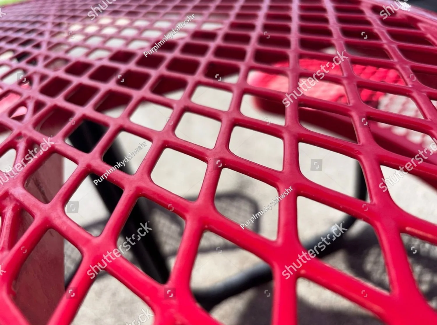 stock-photo-detailed-macro-photograph-of-a-red-powder-coated-metal-picnic-table-with-a-diamond-mesh-pattern-2648497345.jpg