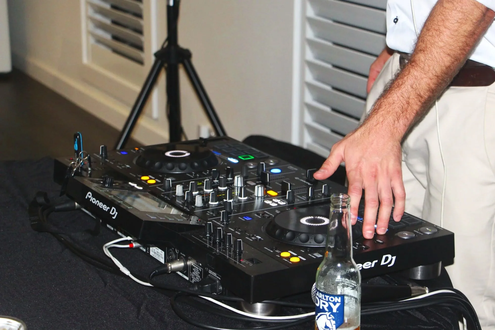 DJ's hand on a Pioneer DJ controller during an engagement party set