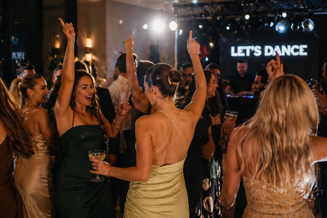 Guests dancing at a wedding with a packed dancefloor