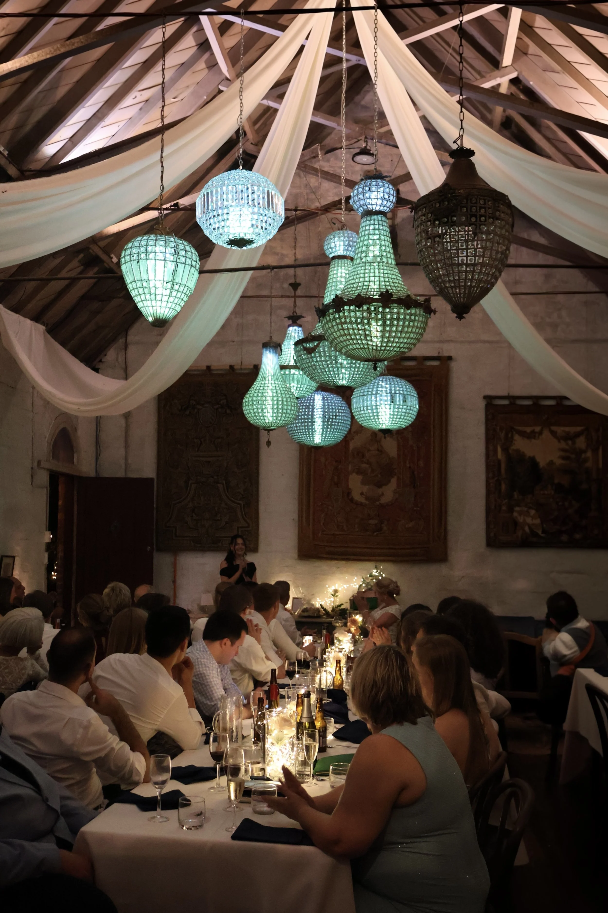 Hanging lanterns and draped ceiling over tables at a Sydney celebration