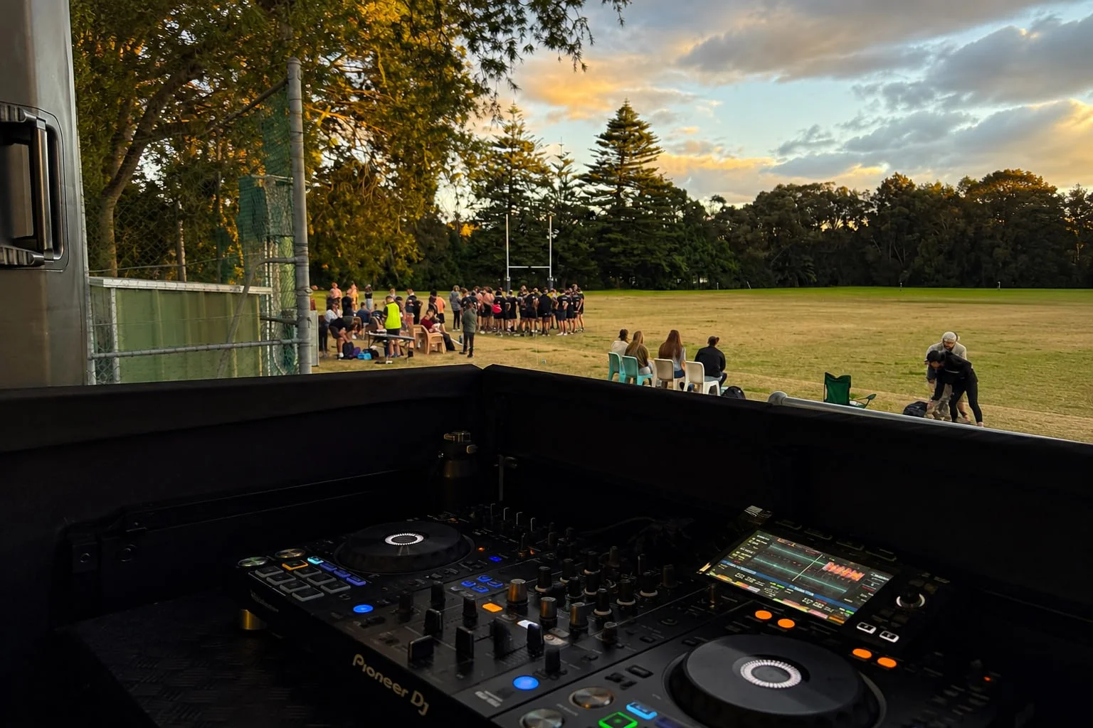 DJ booth overlooking the rugby field at sunset during a Latin Round game