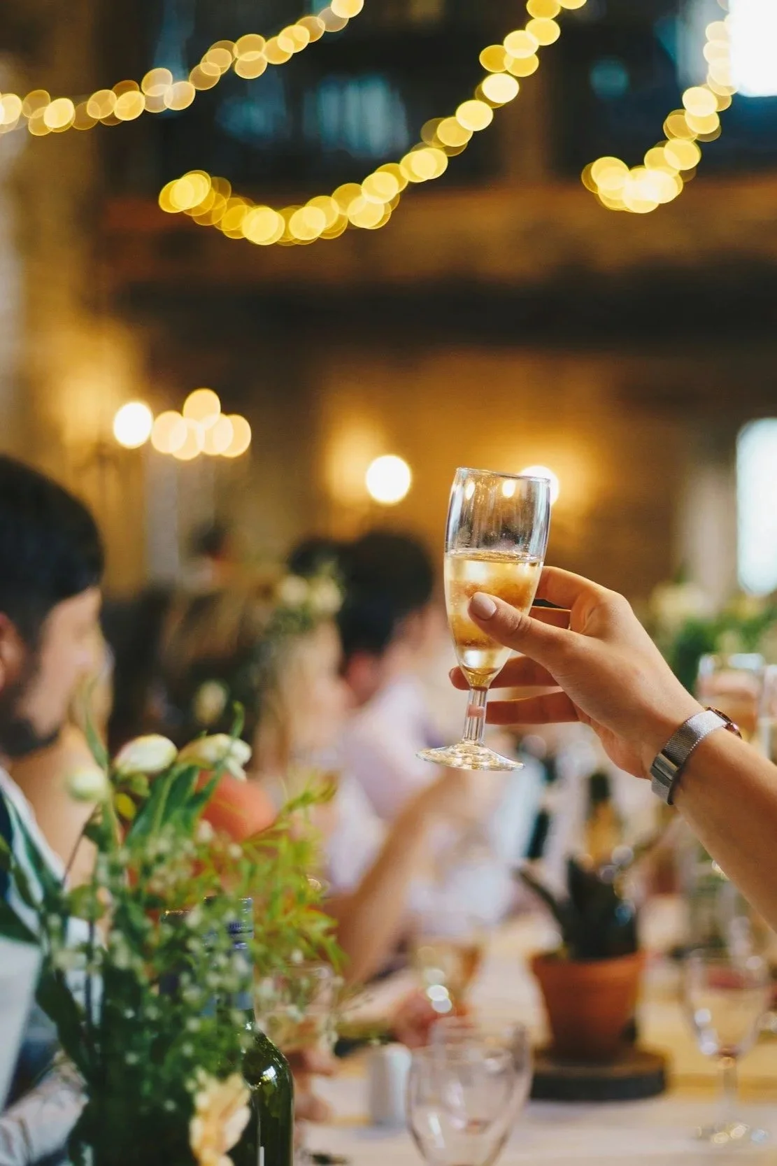 Champagne glass raised at a wedding in Dee Why, Sydney
