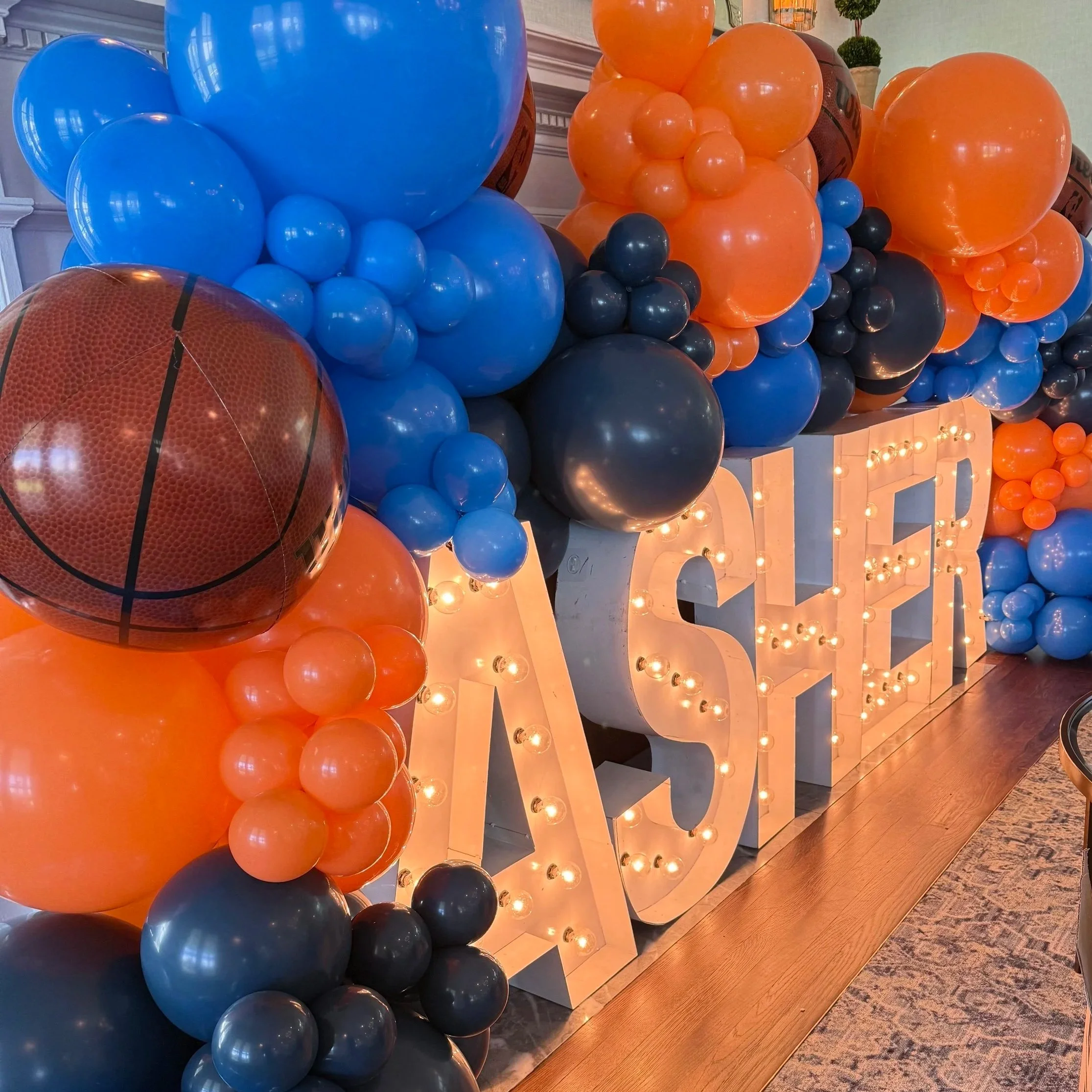Blue, navy and orange balloons accent light up name letter from AlphaLit for a Bar Mitzvah at Brooklawn Country Club in Fairfield CT.