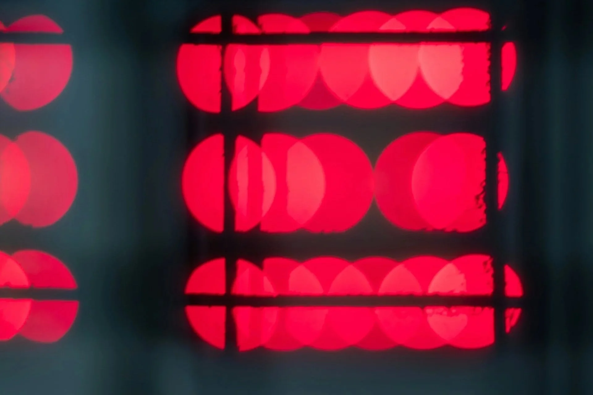 Close-up of a digital scoreboard displaying red illuminated numbers and other information.