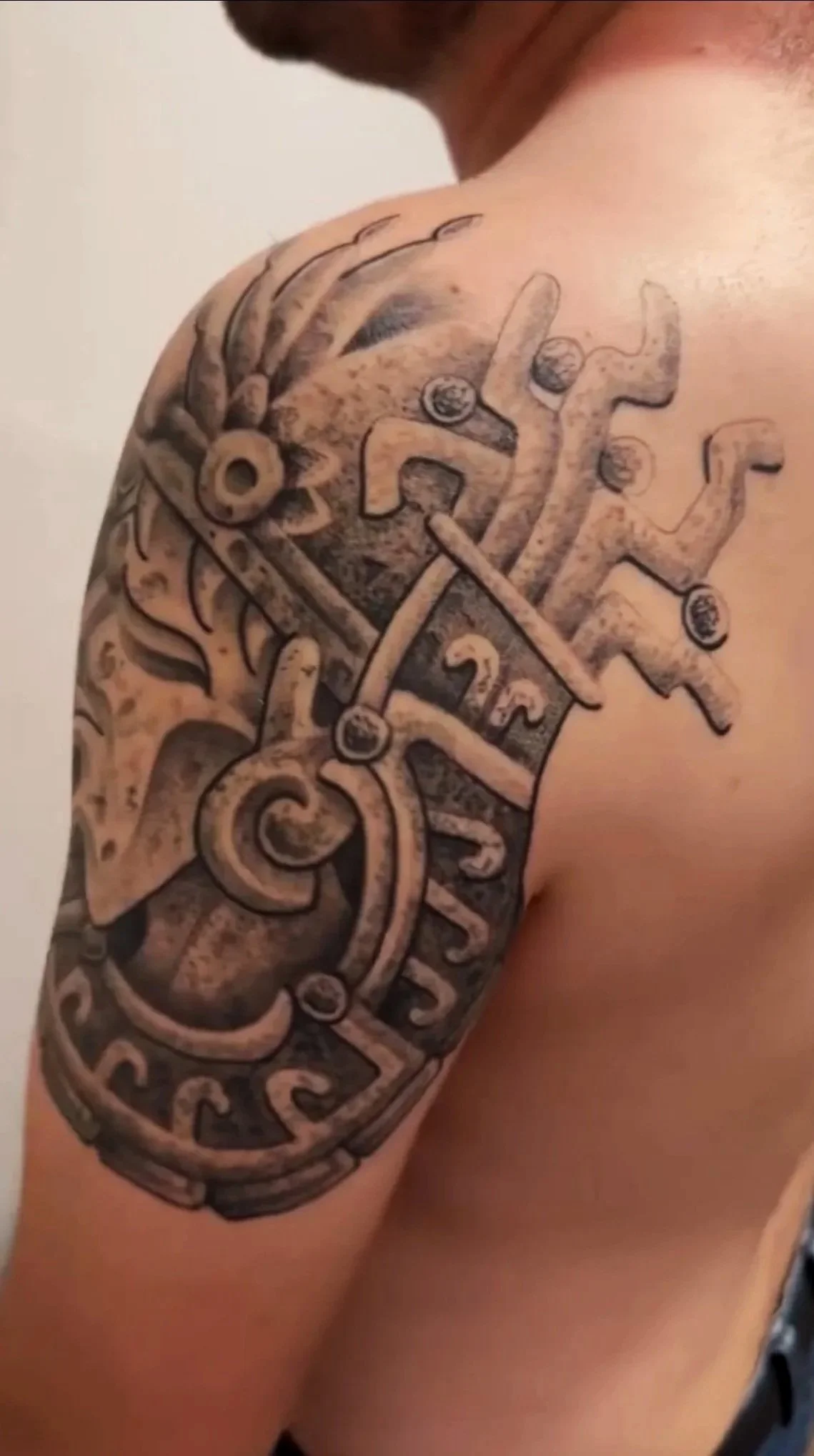 healed mexica tattoo on the shoulder