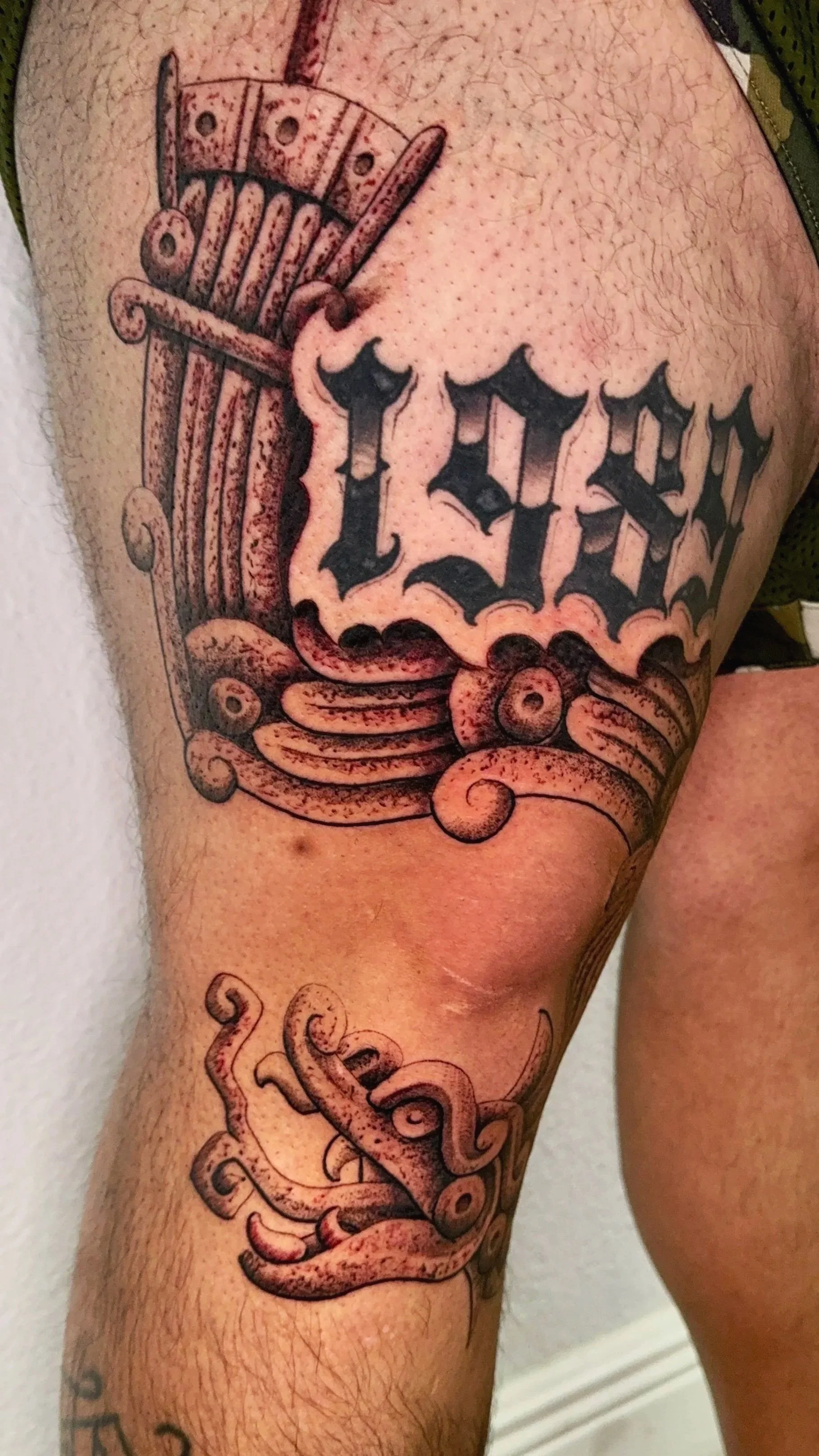 quetzalcoatl knee tattoo 