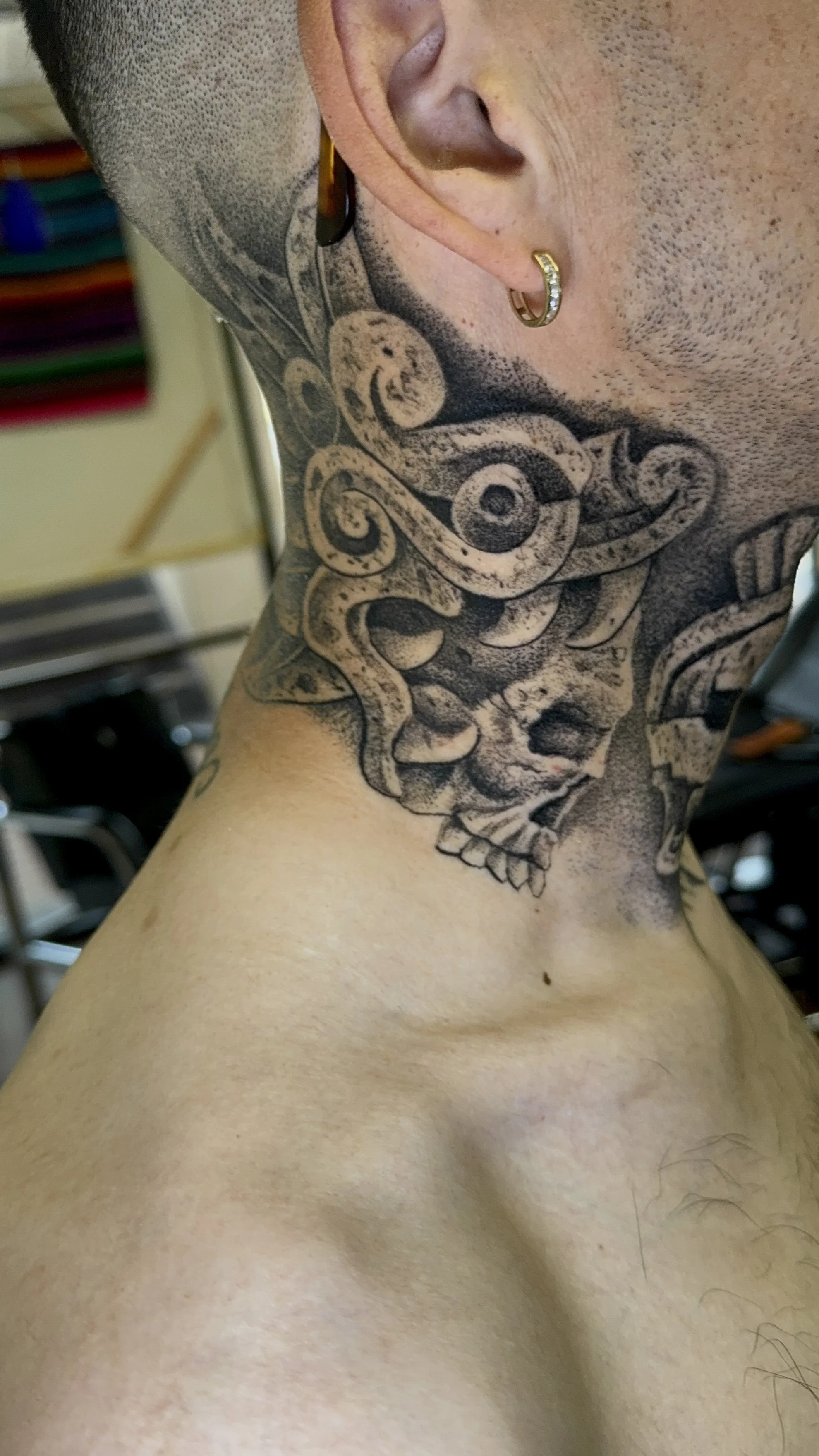 Healed Quetzalcoatl tattoo with stone texture 