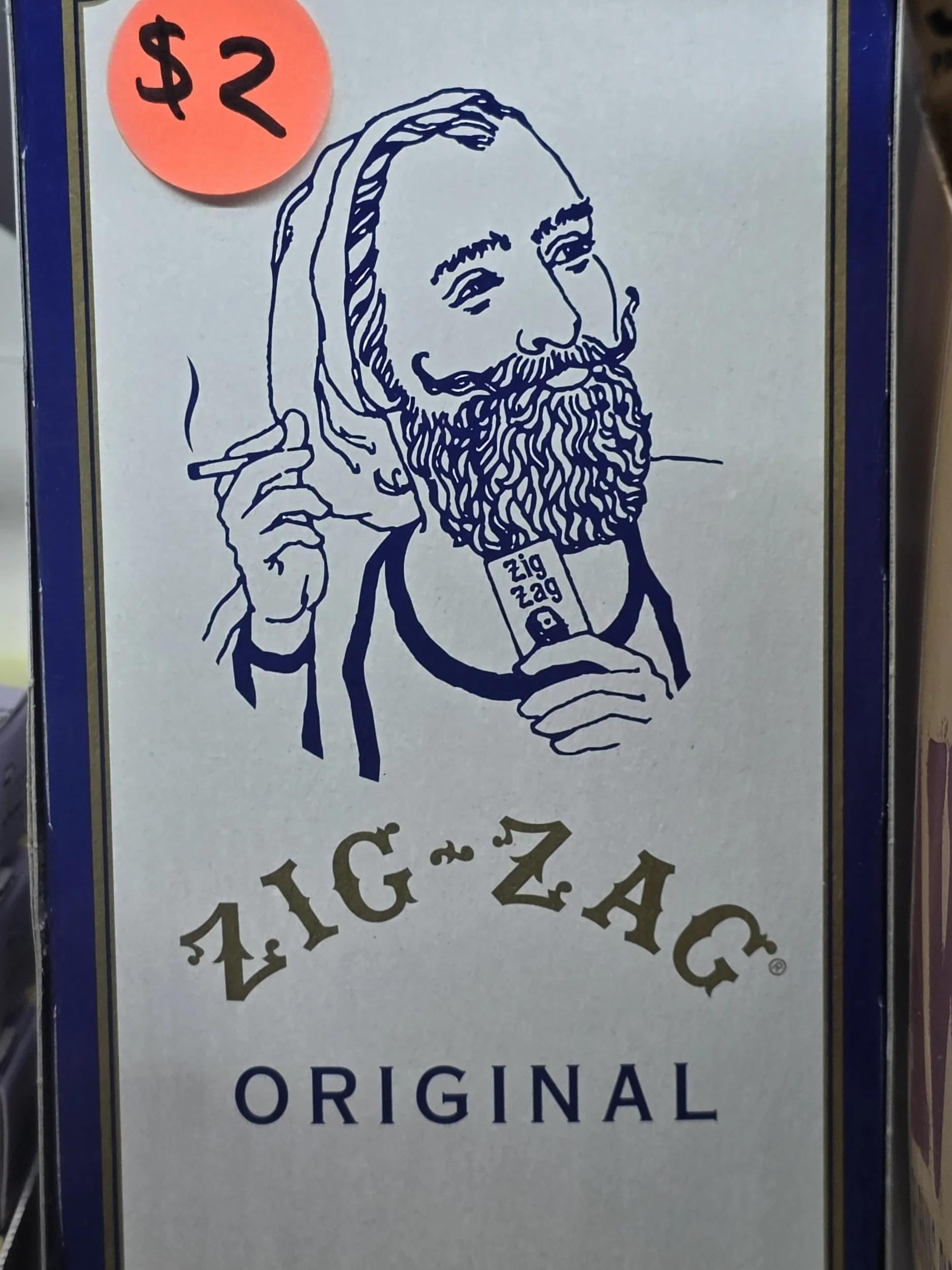 Line drawing of a bearded man with a hat, holding a cigar in one hand with text that says "zig zag"