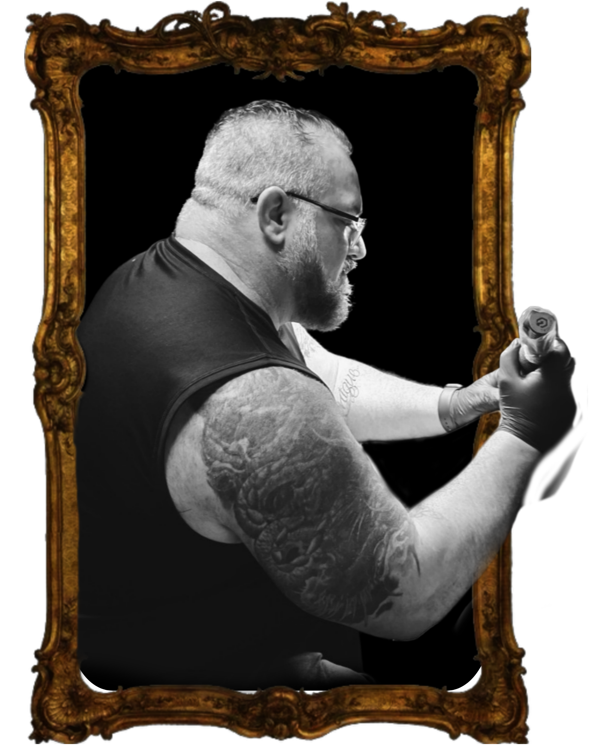 A black and white photo of a muscular man with tattoos on his arm, wearing glasses, and flexing his arm, surrounded by an ornate gold frame.