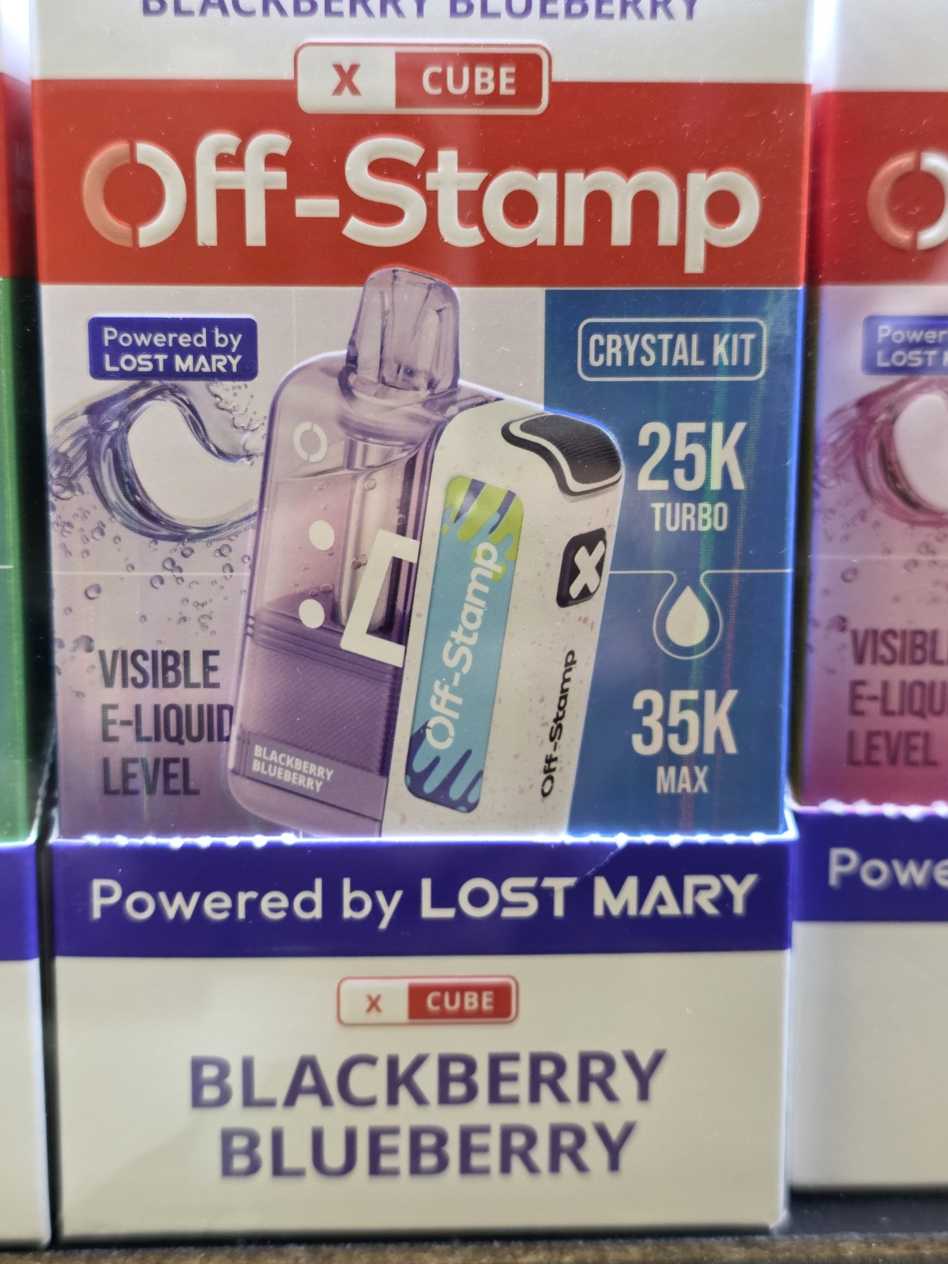 Box of Blackberry Blueberry flavored off-stamp energizing cubes with a visible image of a purple and black energy cube, labeled as a crystal kit with turbo 25K, 35K max levels, powered by Lost Mary.
