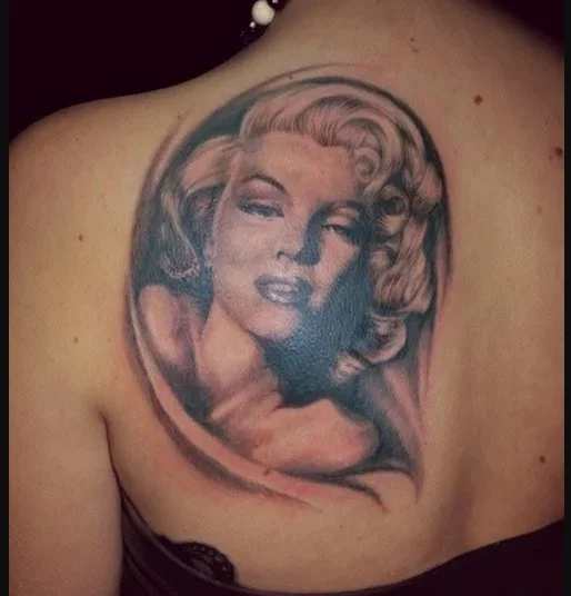 Portrait Tattoo of Marilyn Monroe on a person's shoulder.