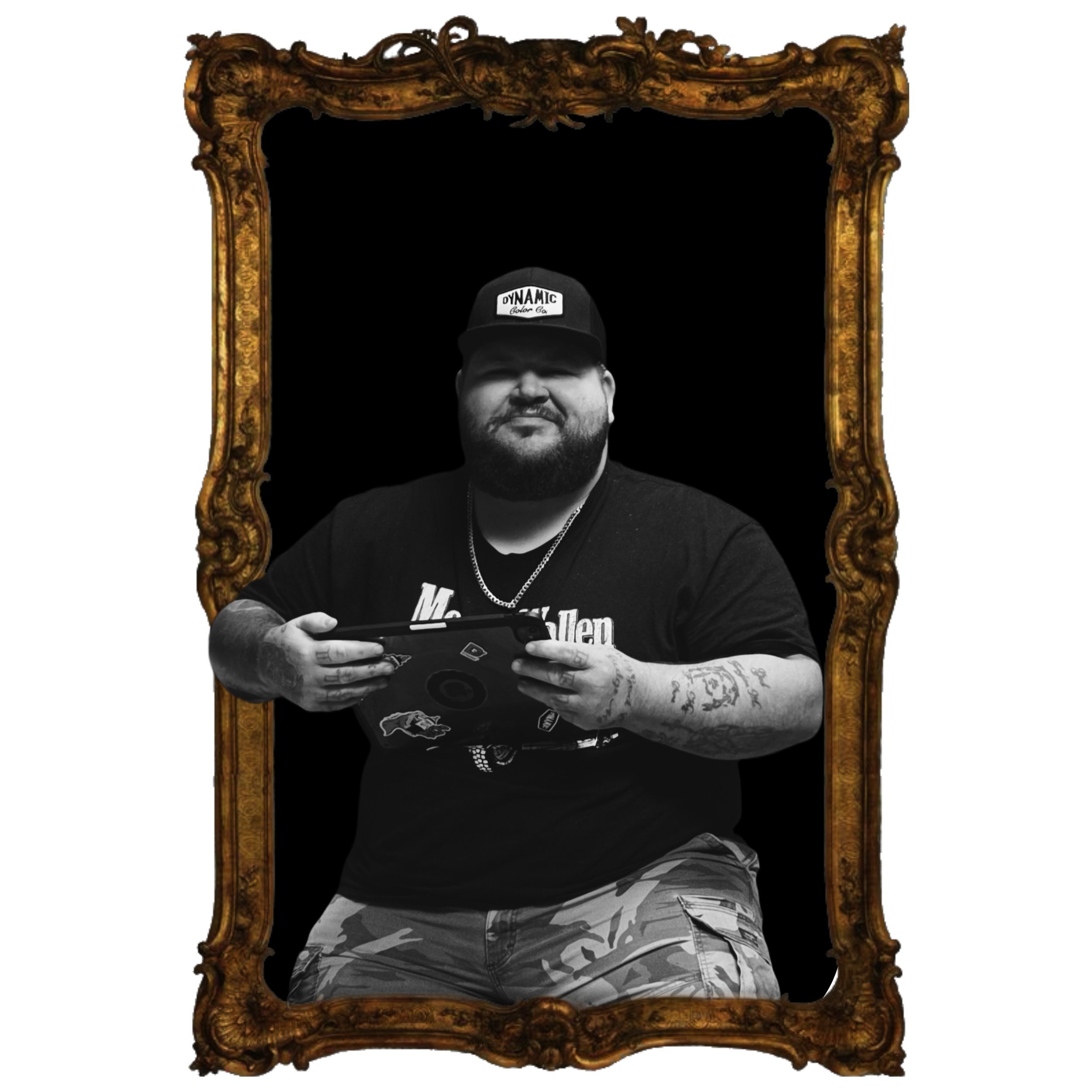 black and white image of tattoo artist mike burton in a gold frame. He is holding an ipad and smiling.