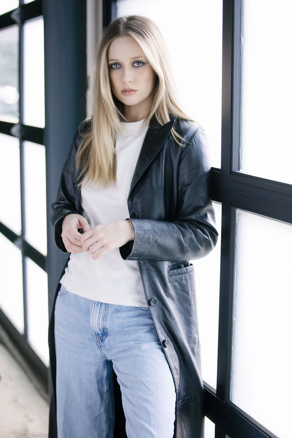 90s makeup, smokey eye, bold lip. Black leather jacket, white t-shirt, light wash jeans