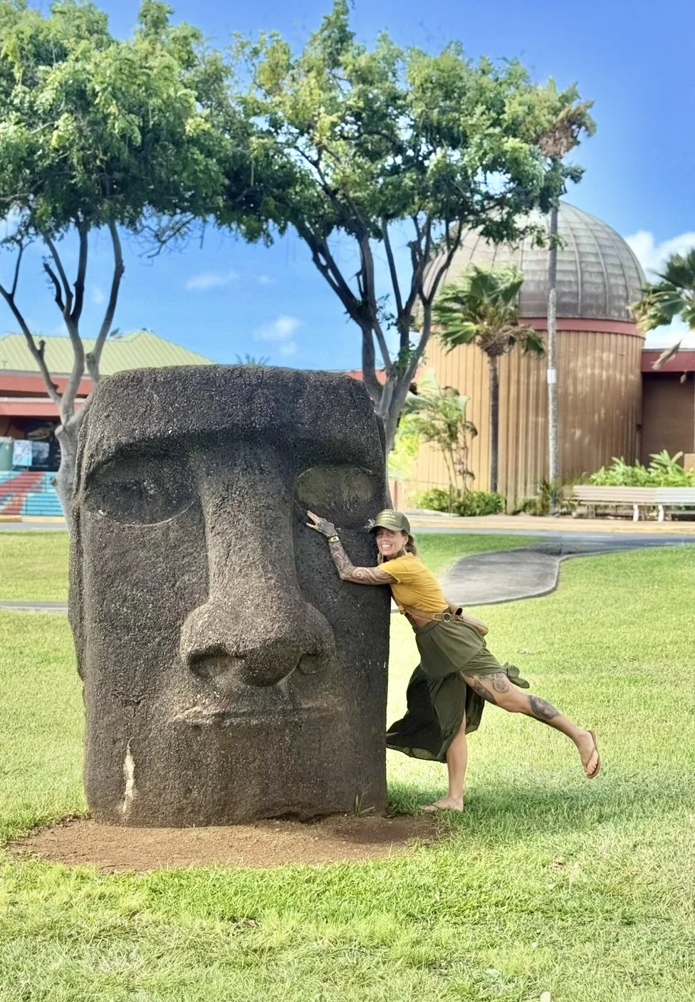 From above hands of unrecognizable woman rubbing aromatic spices into piece of raw meat over parchment paper