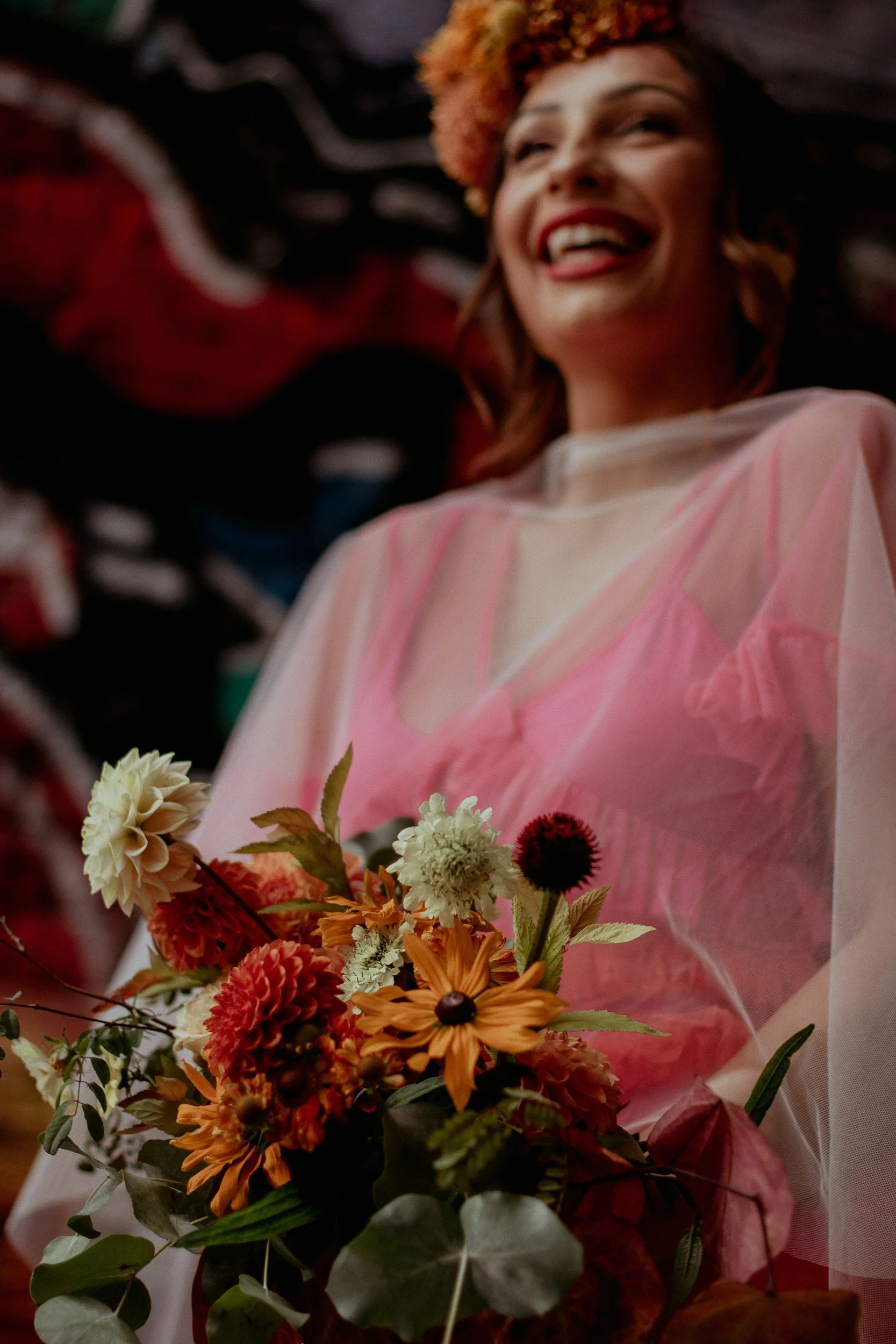 bride in orange and pink with flowers