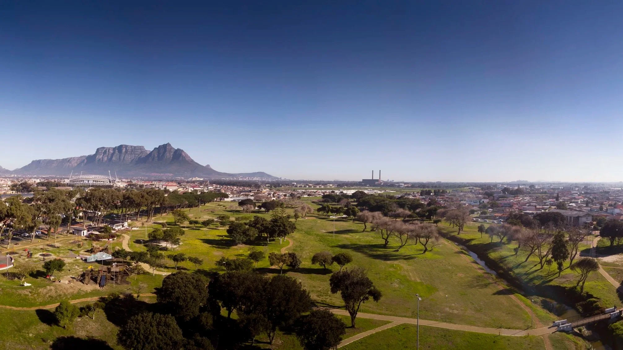 An aerial view of Nantes Park in Cape Town with Athlone Stadium and Table Mountain in the distance