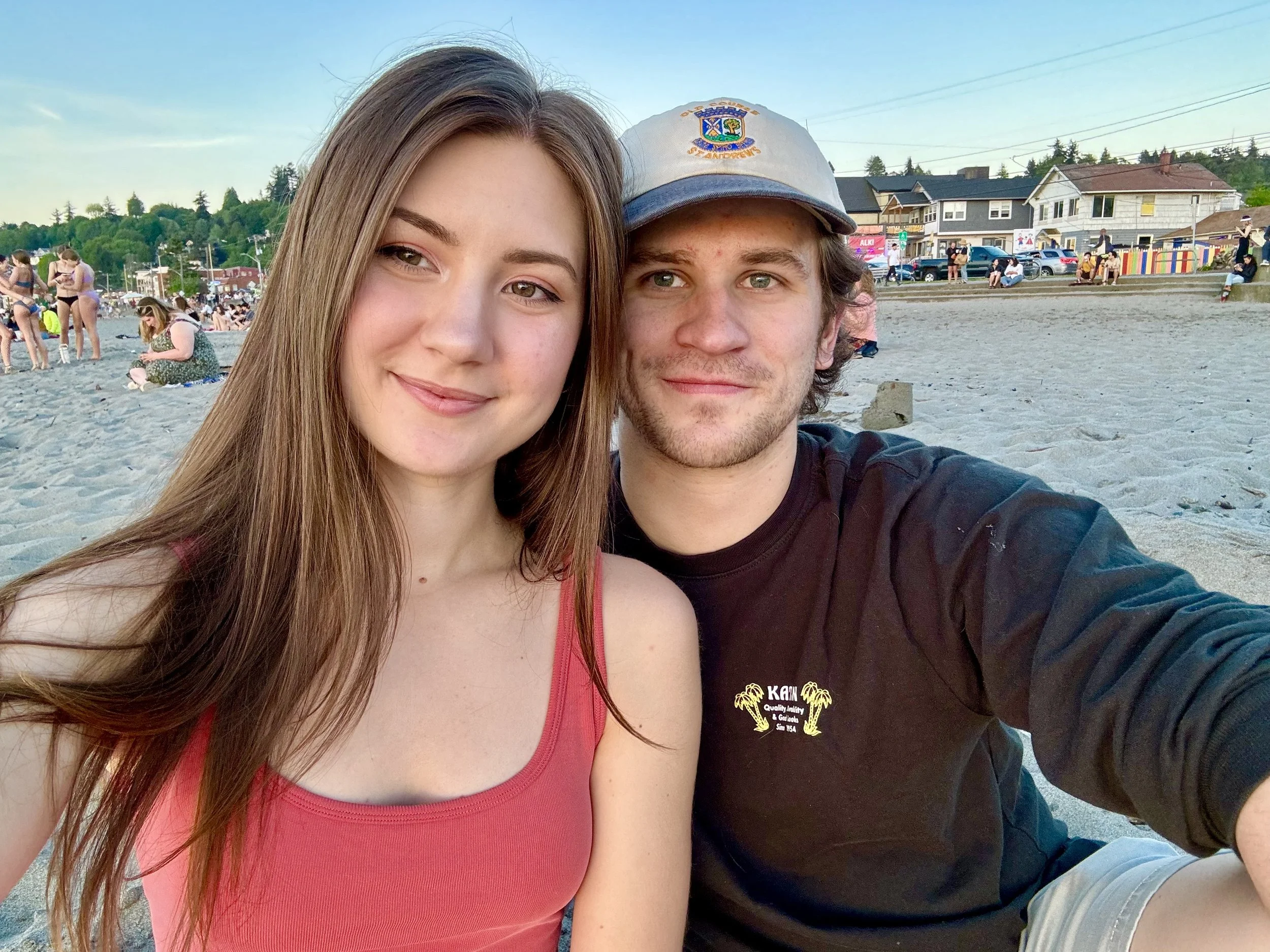 Founder of Lucky Duckies Daycare and her husband, sitting together on a beach in Seattle.
