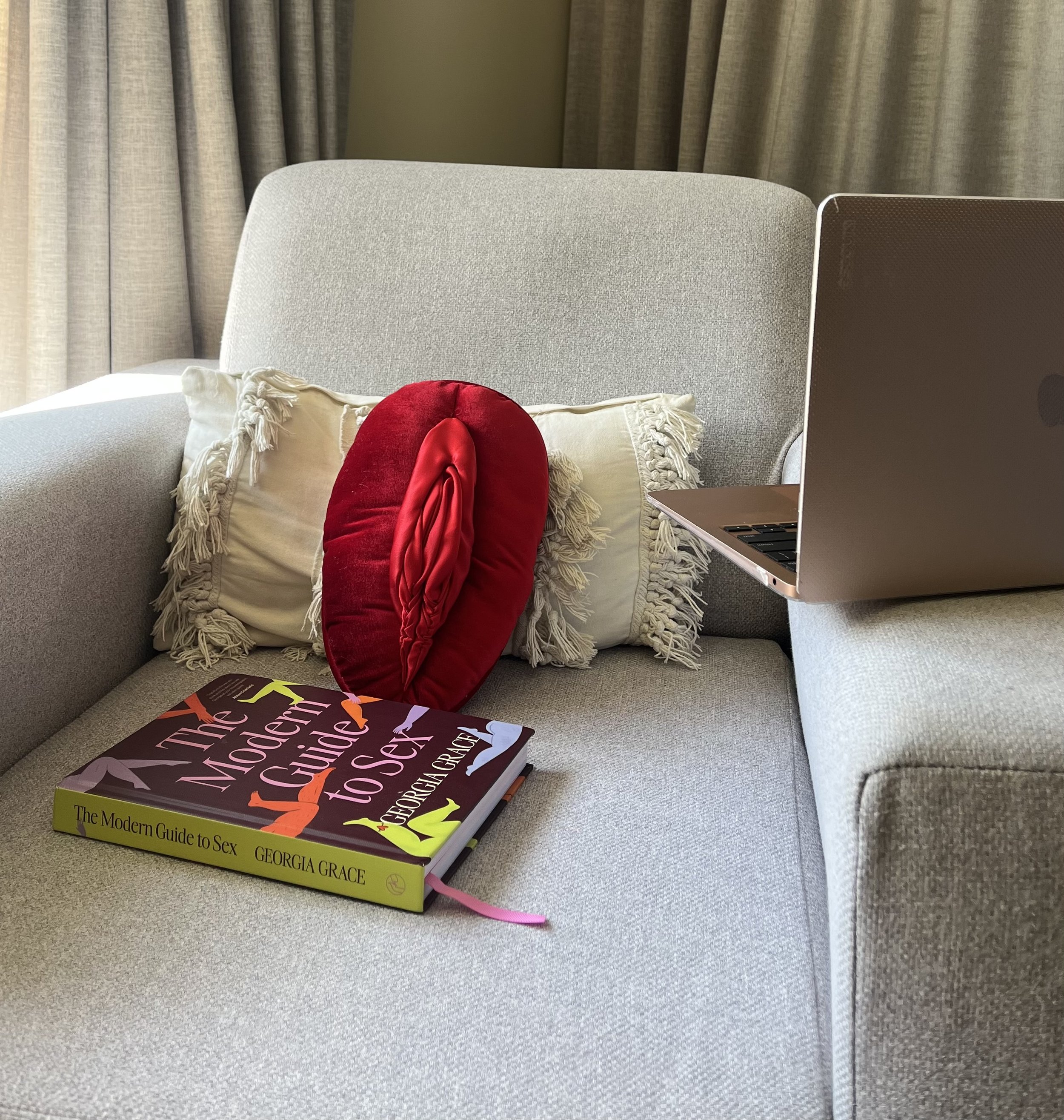 Michaela Tutty has her room set up in a comfortable environment with a vulva model and the book "the modern guide to sex"