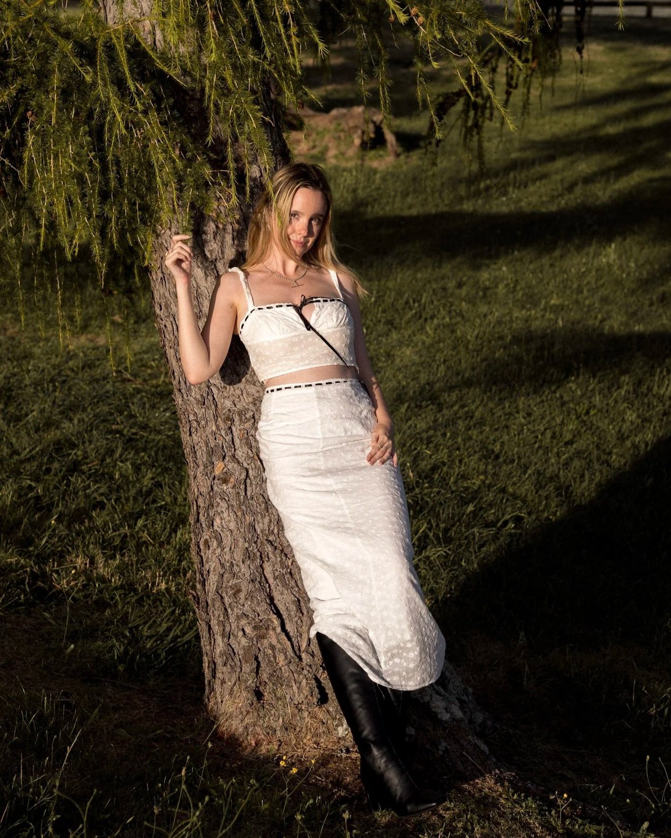 Certified Somatic Sex Coach Michaela Tutty in a portrait leaning against a tree in Taupo, New Zealand