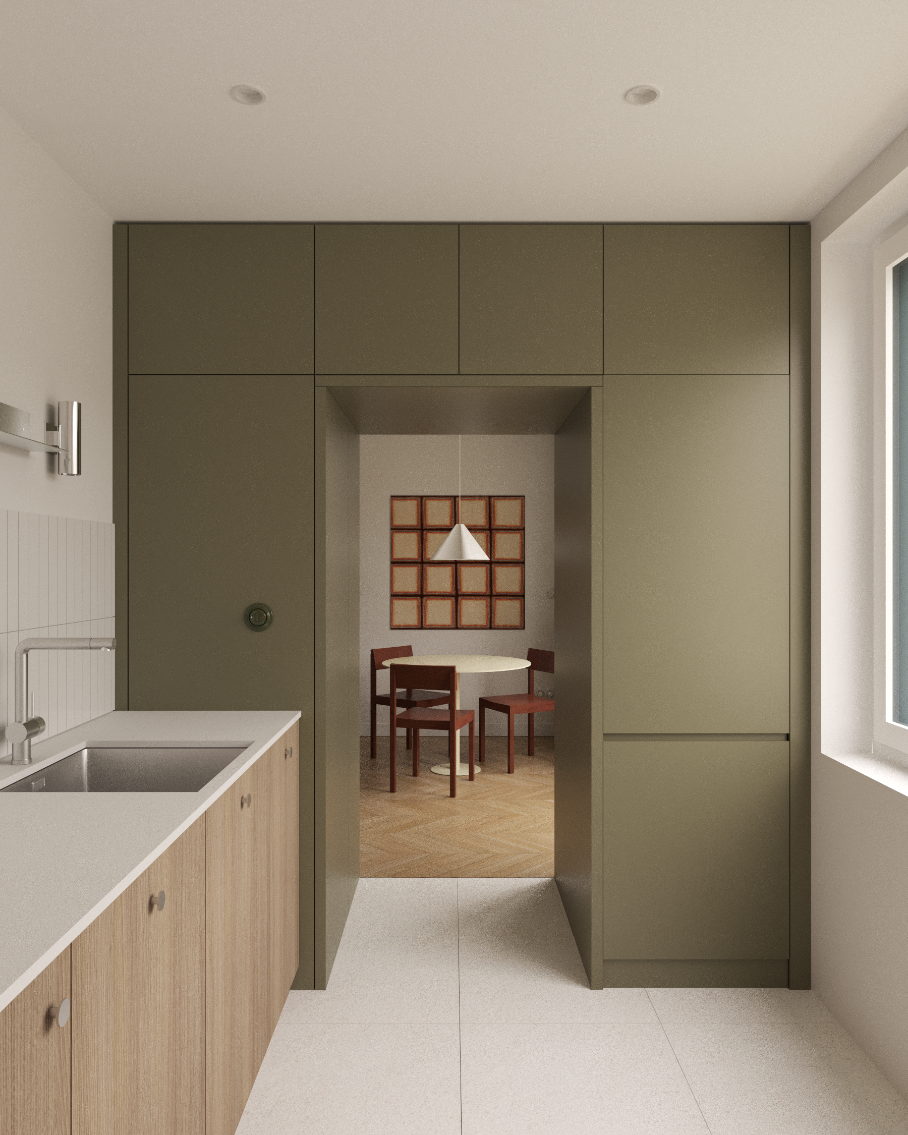 Pohled z moderní kuchyně skrz olivově zelený vestavěný portál do jídelny se závěsným svítidlem, design Cimra Studio