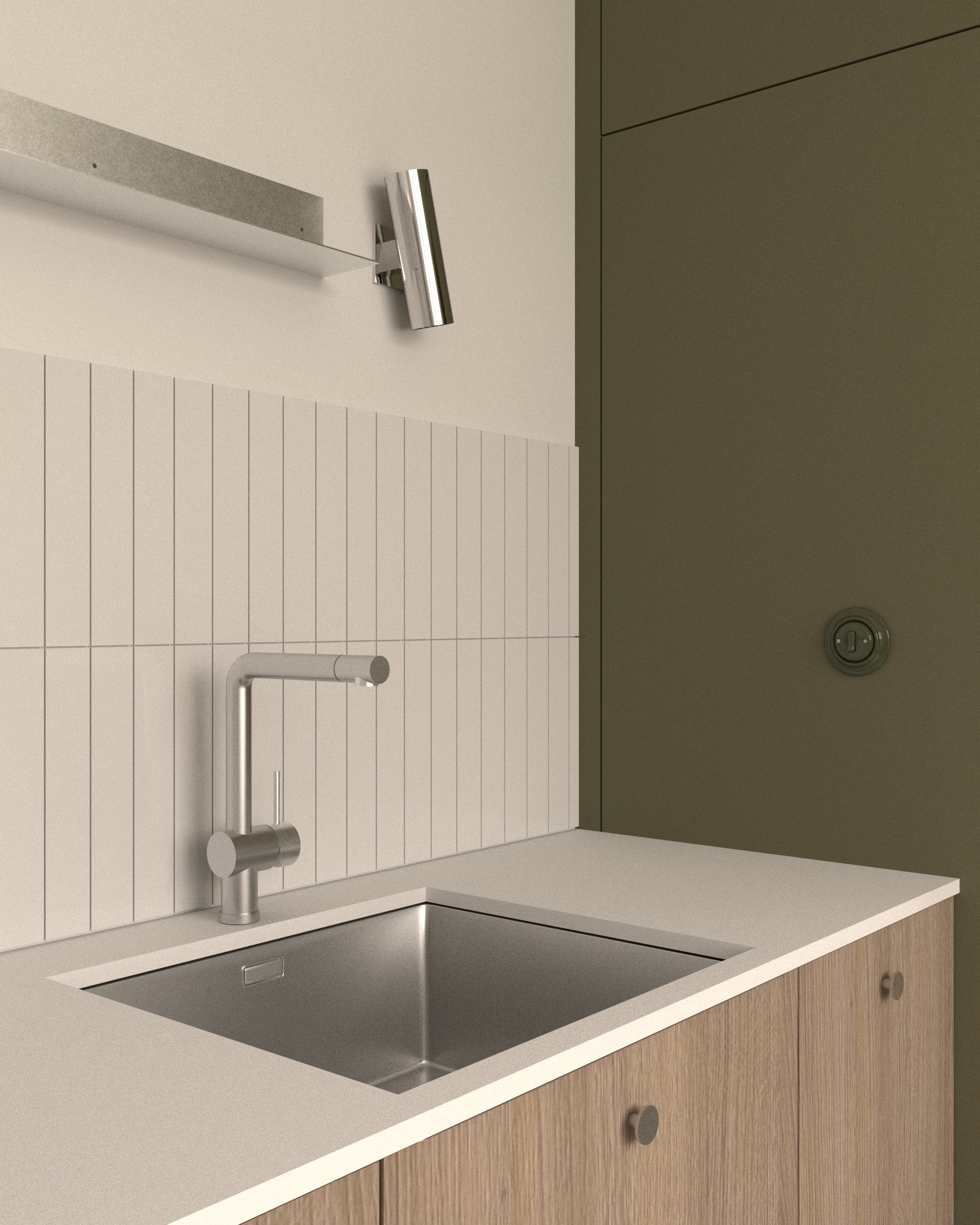 Detail napojení kuchyňské pracovní desky na olivově zelenou stěnu s designovým otočným vypínačem.