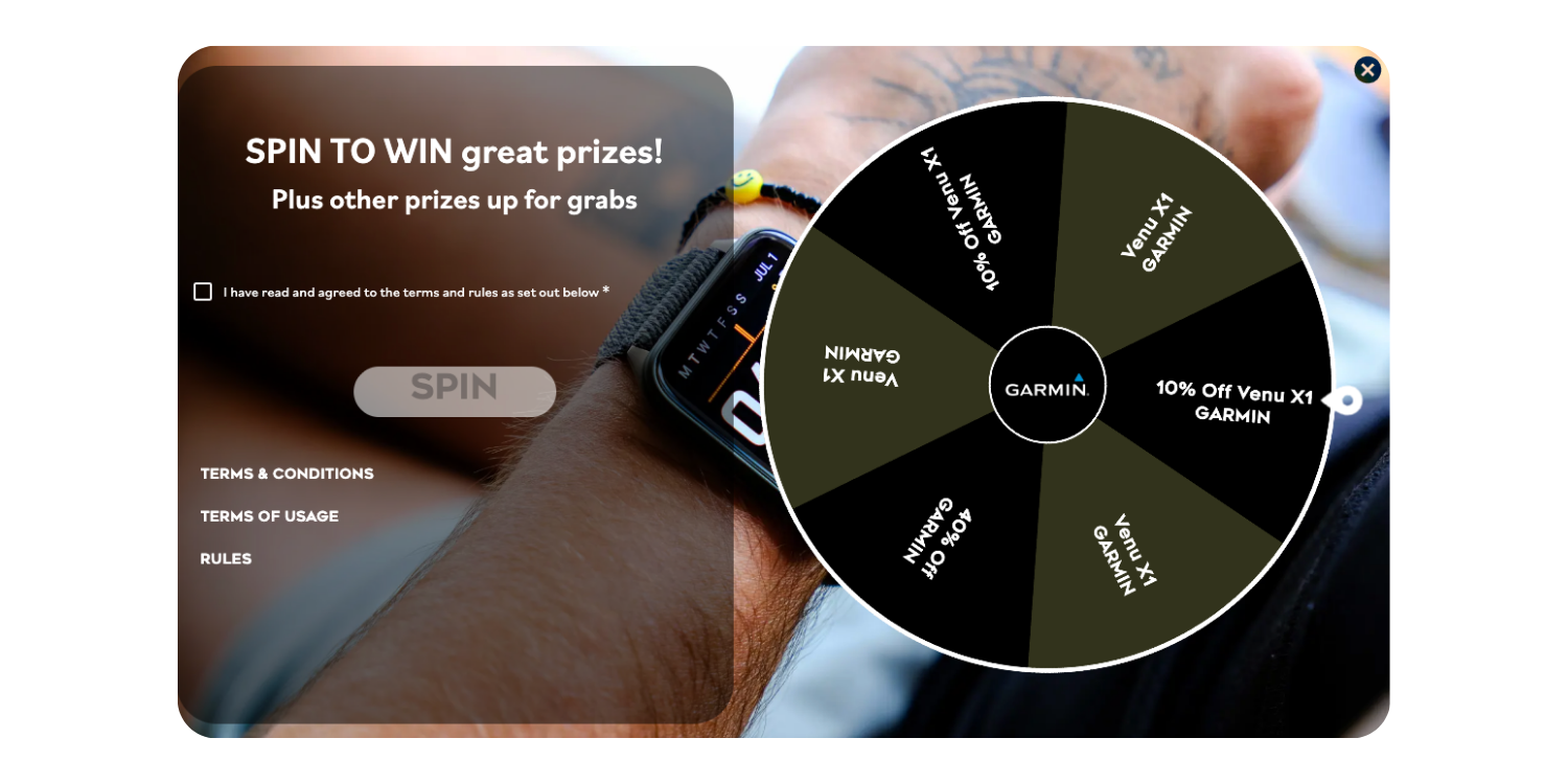 A person wearing a Garmin smartwatch spinning a prize wheel for a chance to win prizes and discounts, with options to read terms and conditions.
