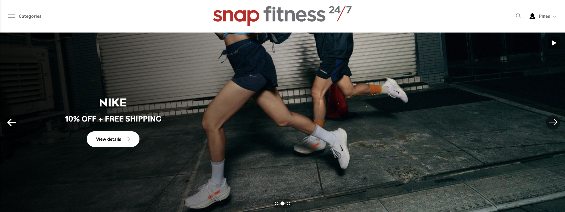 Two people running outdoors at night, wearing athletic shorts and sneakers.