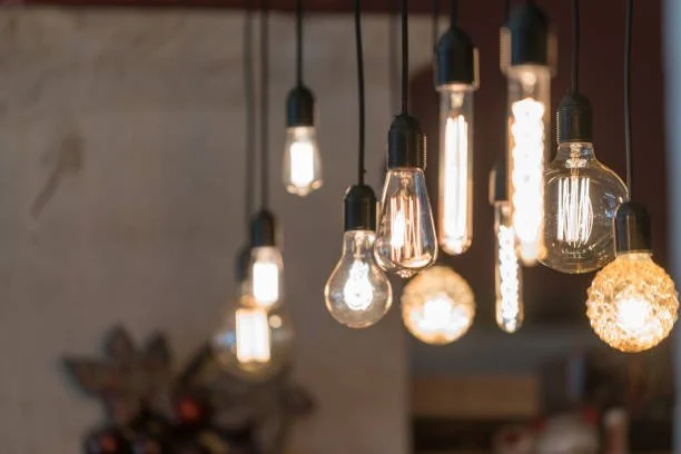 Multiple hanging Edison-style light bulbs with warm glow in a modern interior