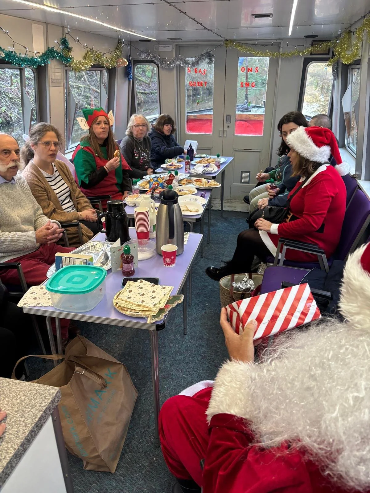 Santa with a gift and other people