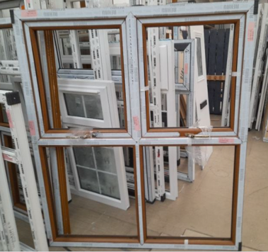 Four double-pane windows stacked on display in a store.