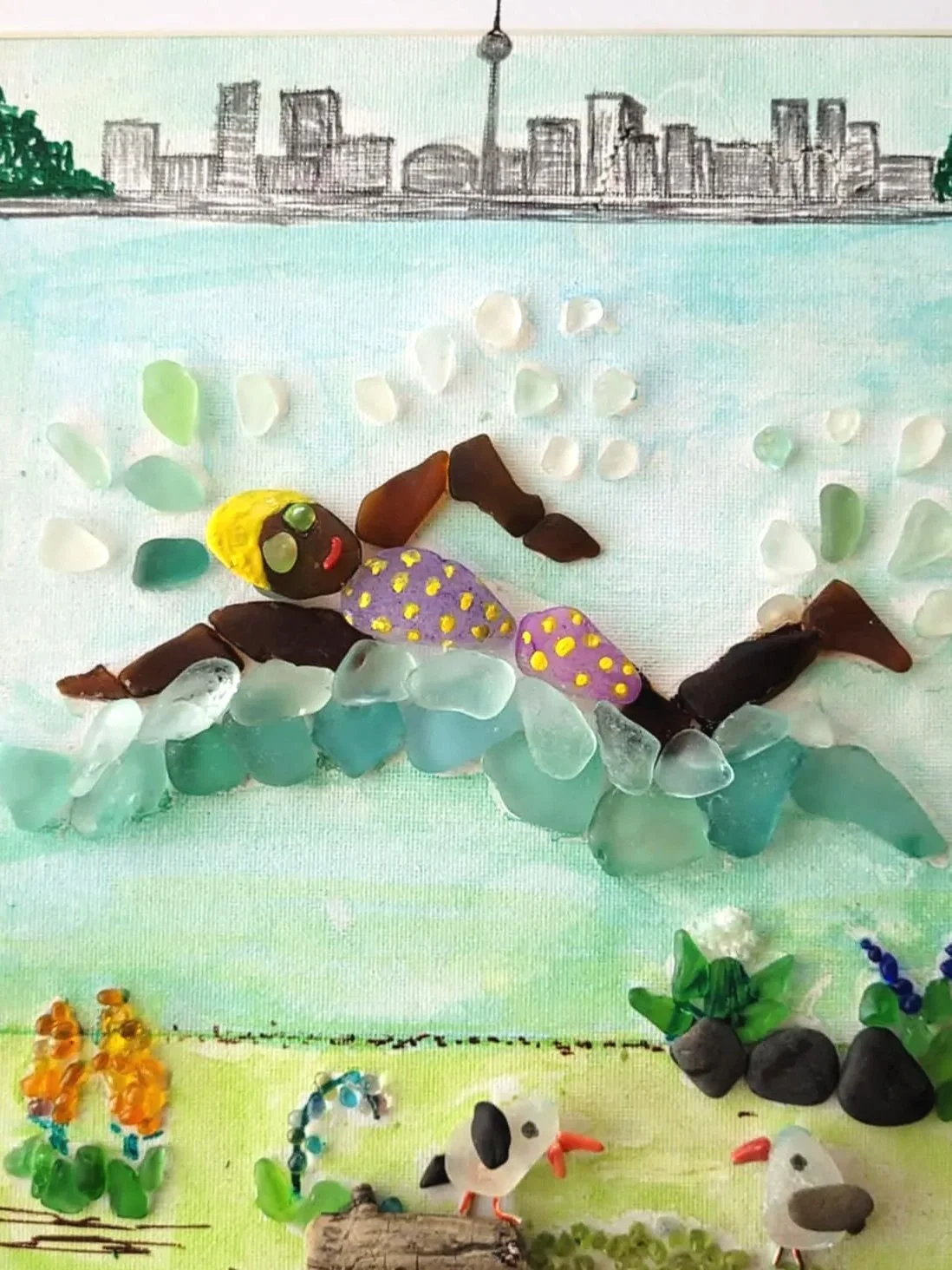 A seagall and mixed media fine art piece depicting a person swimming in Ontario Lake with Toronto skyline and CN tower in the background.