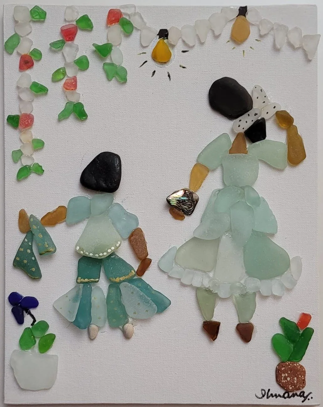 Mosaic art of two women in traditional dresses made with sea glass and small stones, with potted plants nearby.