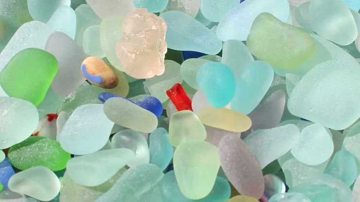 Close-up of colorful sea glass and small decorative stones.