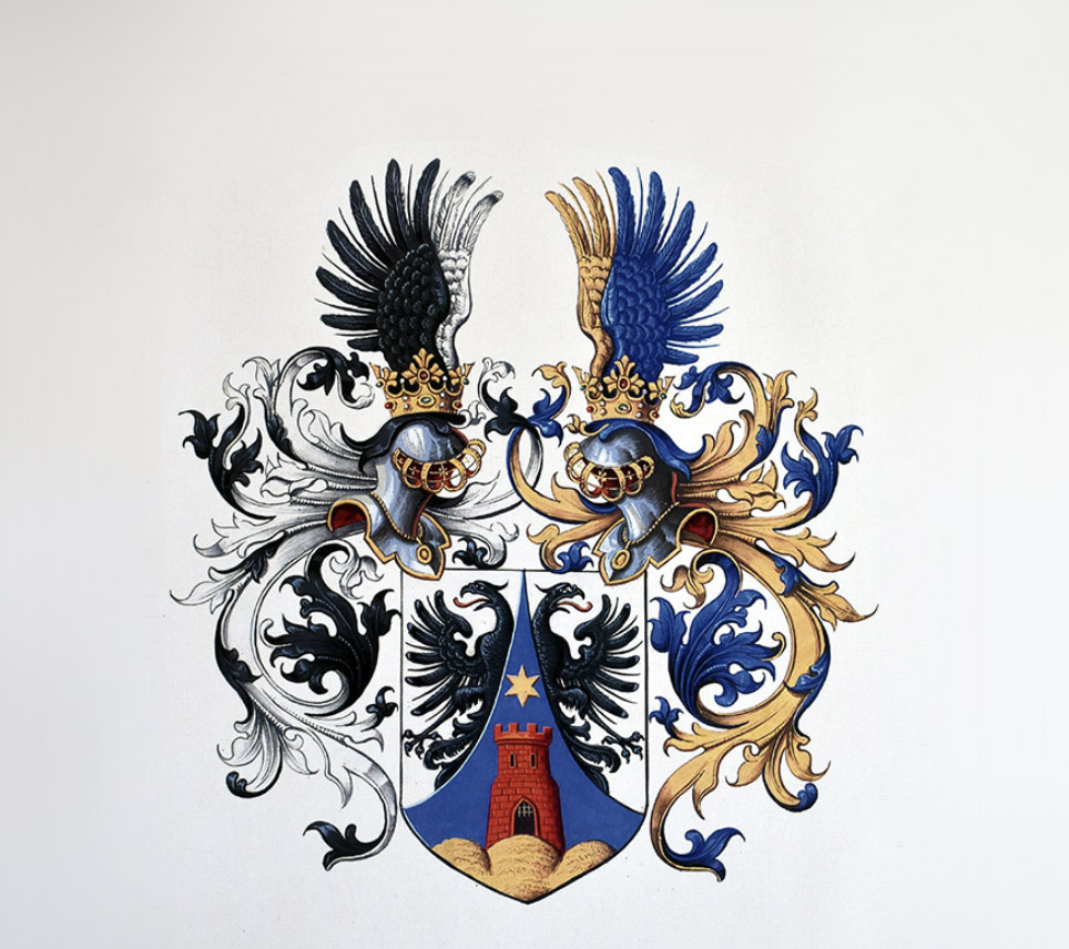 Colorful heraldic coat of arms with two crowned helmets topped with feathers, a shield featuring a black eagle, a red tower, and decorative flourishes.